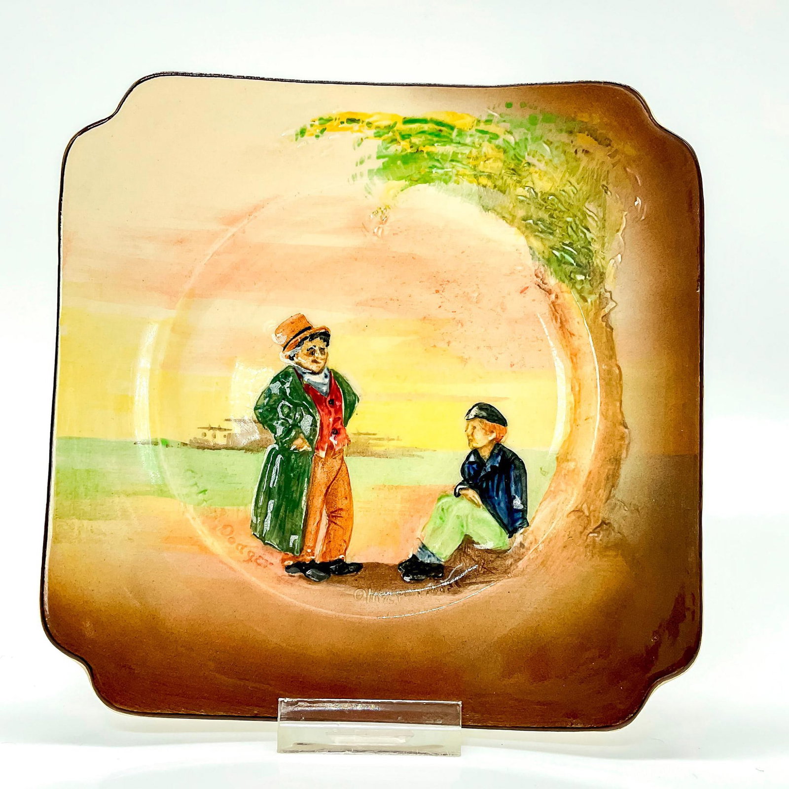 Royal Doulton Seriesware Dickens Plate: Bread and butter plate decorated in low relief with a scene of Oliver Twist and Artful Dodger, characters from Charles Dickens victorian novel. Royal Doulton backstamp. Issued: c. 1908 Dimensions: 4.7