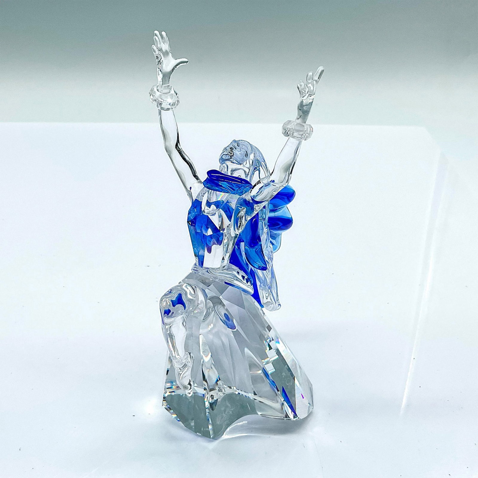 Swarovski Crystal Figurine, Isadora: Annual edition lead crystal first edition of the Magic of Dance trilogy. Isadora is depicted in clear and blue crystal with moveable bracelets on her wrists. Swarovski etched backstamp. This item has 
