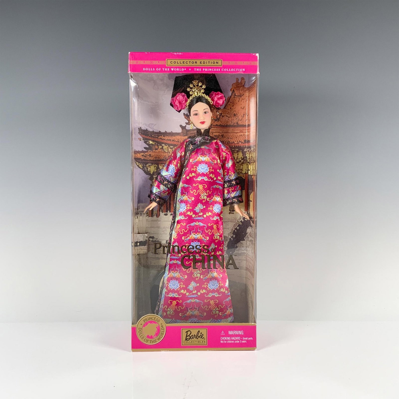 Mattel Dolls of the World Barbie, Princess of China: Dressed in a resplendent pink Chinese gown adorned with delicate flowers, her hair adorned with matching blossoms and topped with a shimmering crown. Marked Mattel. This item has its original box. Dim