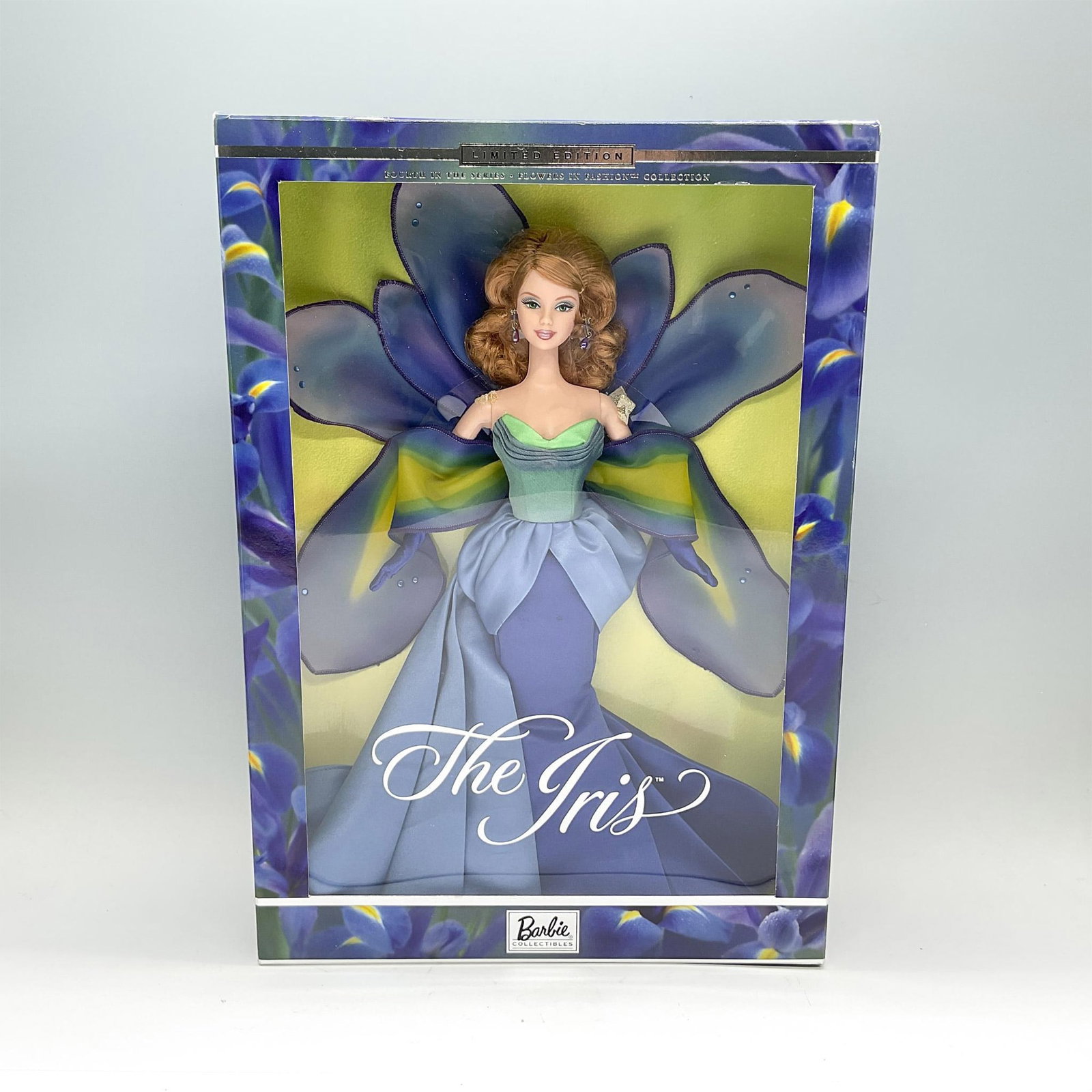 Mattel Barbie Doll, Limited Edition, The Iris: Part of the Barbie Collectibles, and fourth in the Flowers in Fashion collection. Features a caramel-colored hair doll in a stunning gown representing the purple perennial. She is displayed in her ori