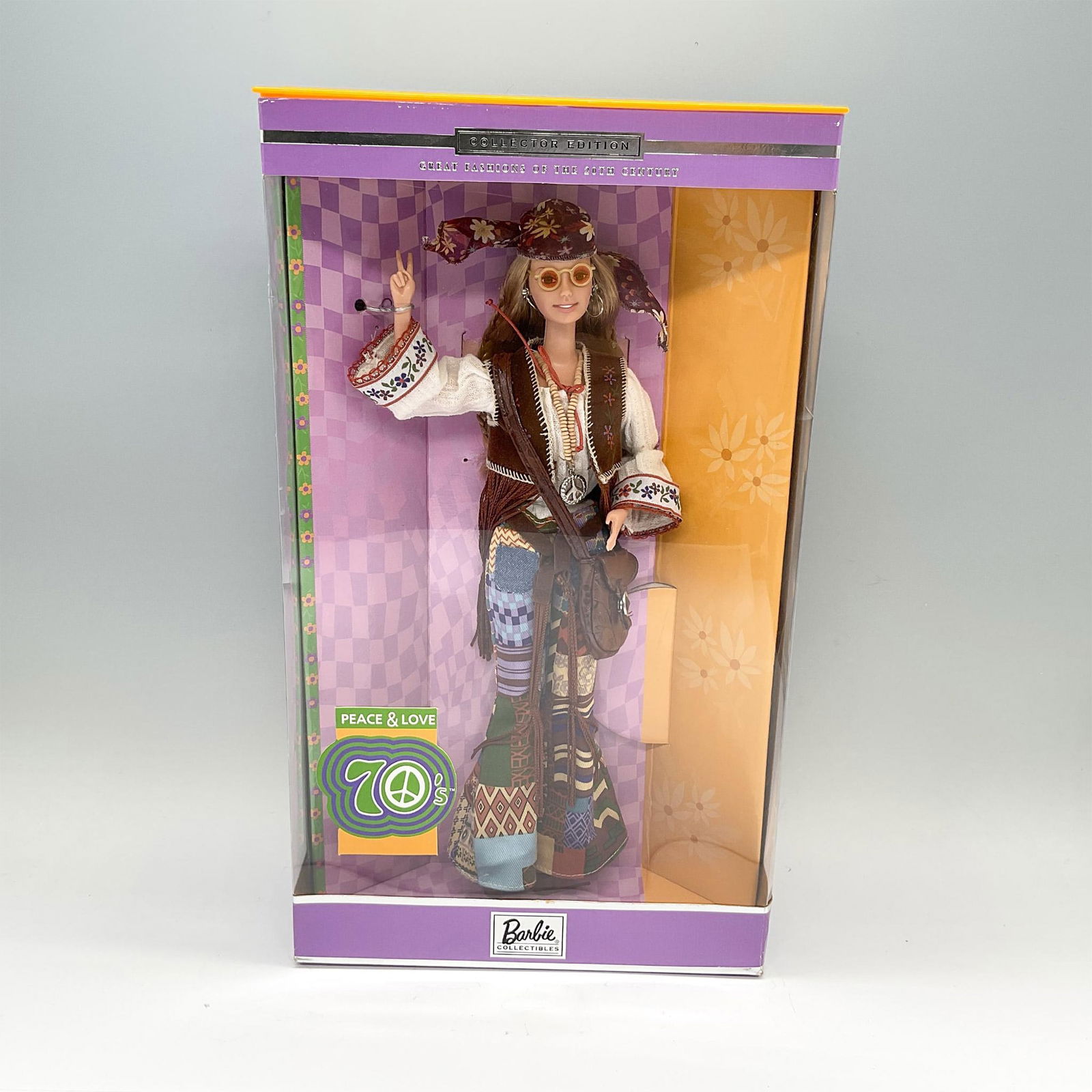 Mattel Collector Edition Barbie Doll, Peace & Love 70's: A Barbie Collectibles, and the seventh in the Great Fashions of the 20th Century collection. Barbie is shown in a long sandy-brown hair and groovy attire. She is displayed in her original and unopened