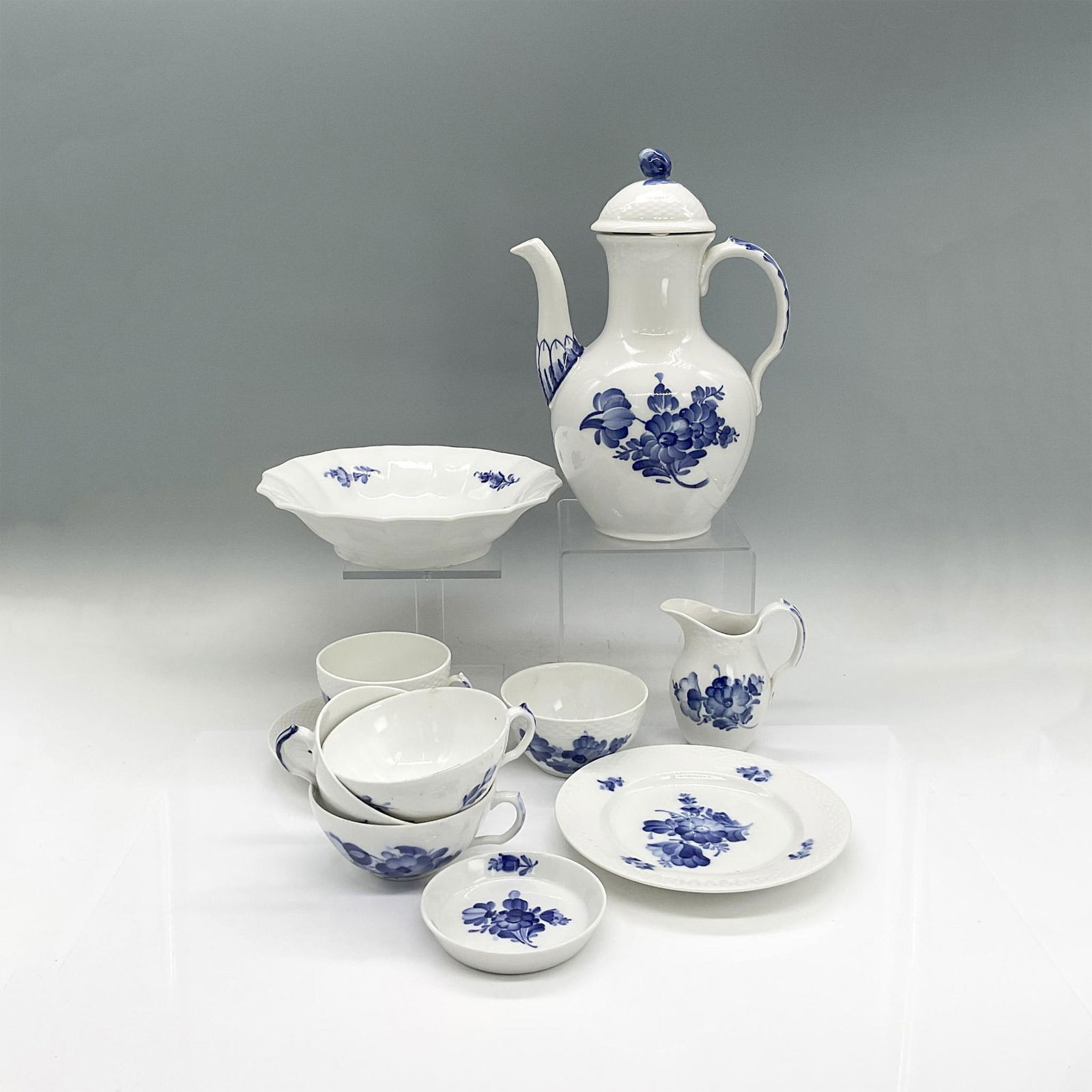 11pc Royal Copenhagen Coffee Pot/Cups/Plate/Knife Rests: White porcelain serveware with blue floral pattern. Small open sugar bowl. Teacup and saucer. Coffee pot 7.25"L x 4.25"W x 9.5"H. Appetizer plate 0.75"H x 6.25" dia. Bowl 2"H x 8" dia. Three tea cups