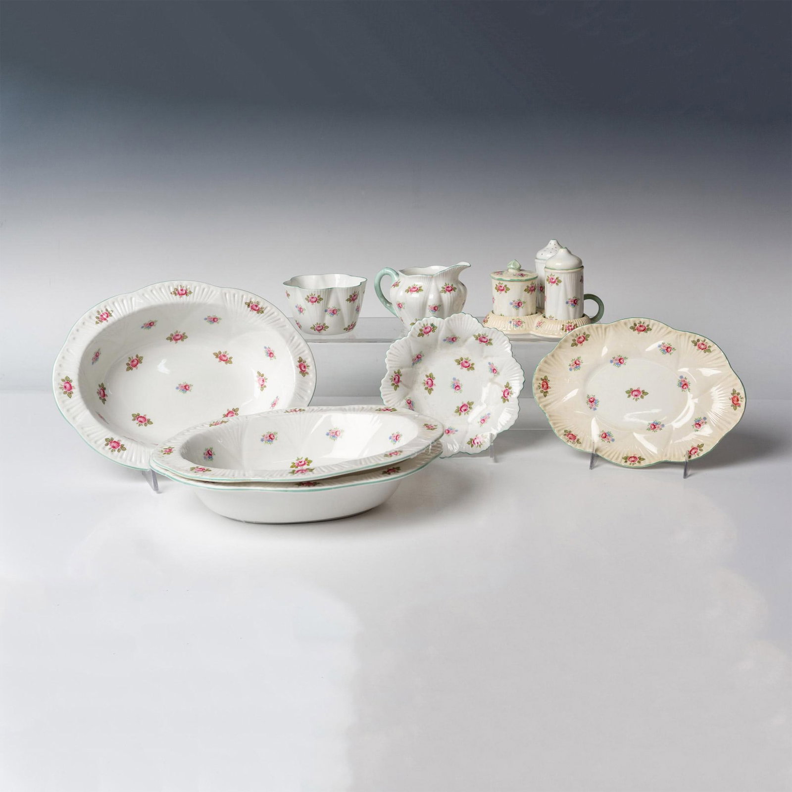8pc Shelley Bone China Server Ware, Rosebud: Set includes 3 - side dish oval bowls 9.5", 1 - small oval plate 7.5", 1- creamer jug, 1 - sugar bowl, 1 - round underplate 5" and 1 - Salt, Pepper & Jam Server 5". Shelley Rosebud backstamp. 13426. I