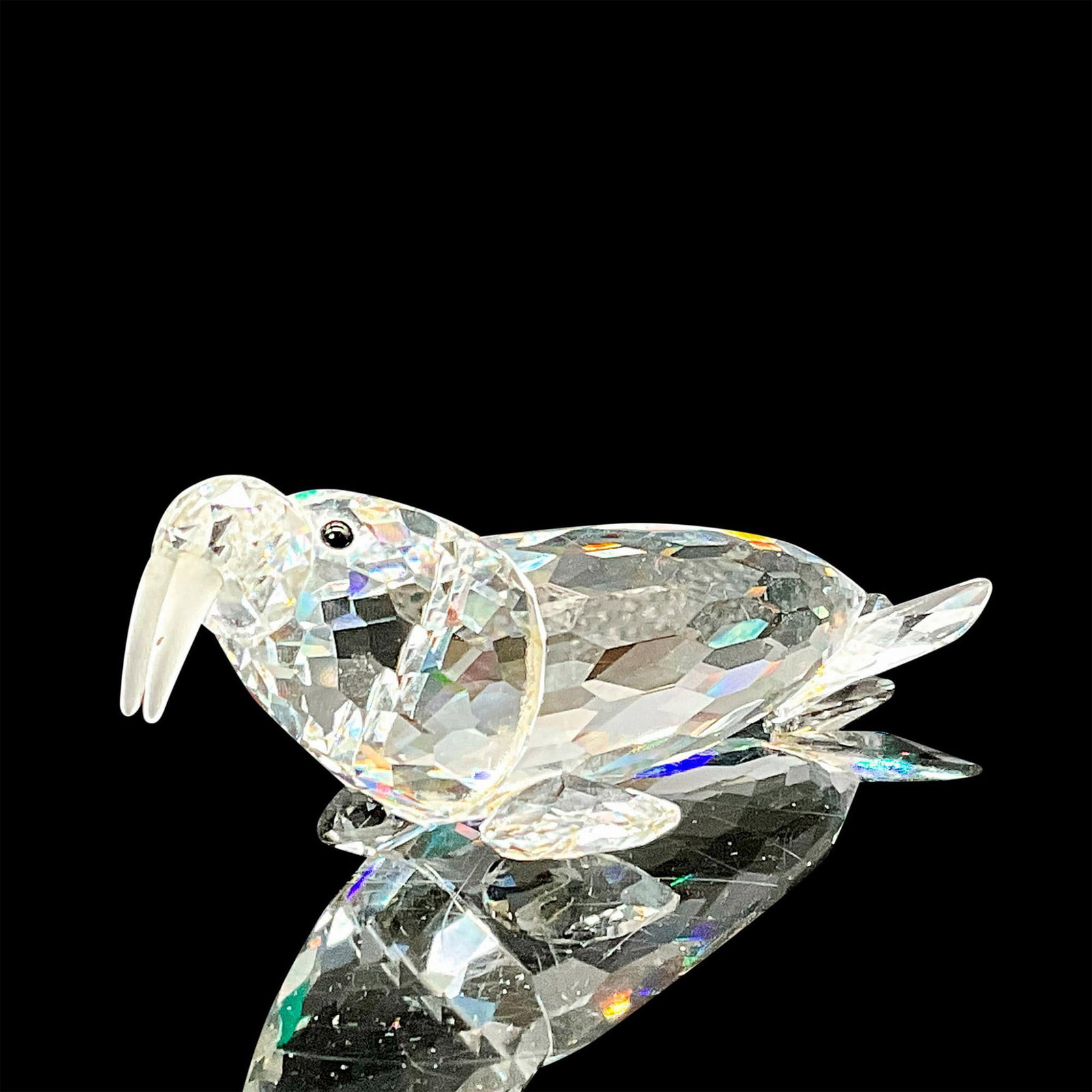 Swarovski Silver Crystal Figurine, Walrus: This Swarovski Silver crystal walrus is made from clear crystal with black eyes and a frosted crystal tusks. Item comes with original box measuring 6.5"H x 3.25"dia. Swarovski backstamp. Issued: 1989-