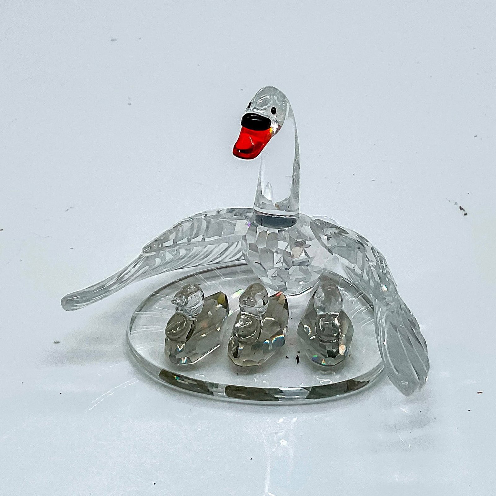 Swarovski Crystal Figurine, Swan Family: Lead crystal part of the Beauties of The Lake collection and is made from clear crystal with jet crystal and orange colored accents. Swarovski etched backstamp. This item has its original box. Box mea