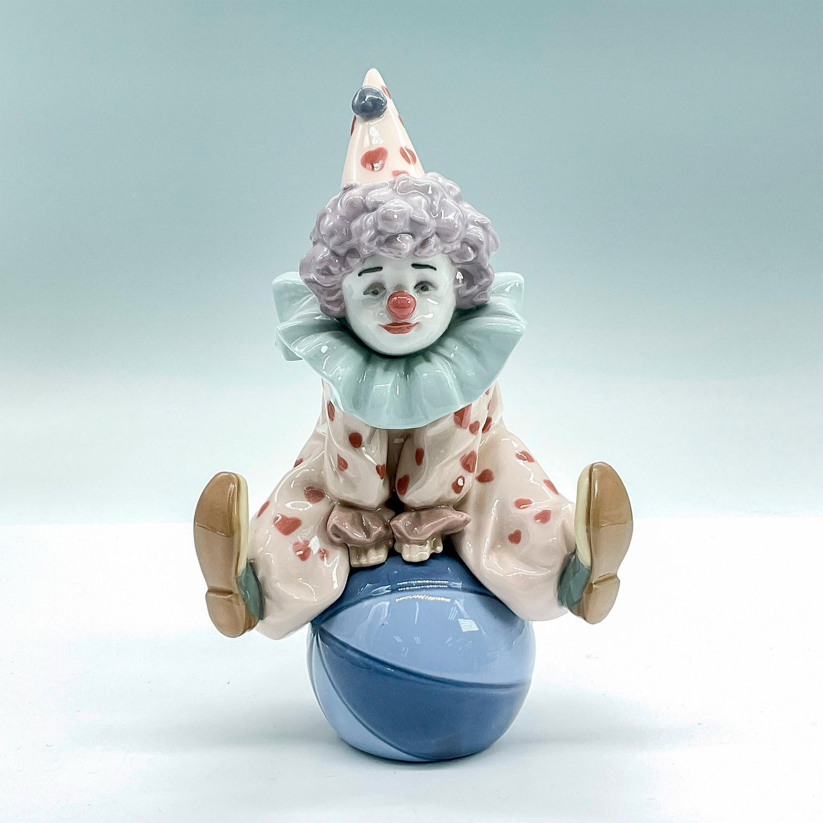 Having A Ball 1005813 - Lladro Porcelain Figurine: Glossy finish; Lladro backstamp. Artist: Antonio Ramos Issued: 1991 - 2018 Dimensions: 7"H x 4"W Manufacturer: Lladro Country of Origin: Spain