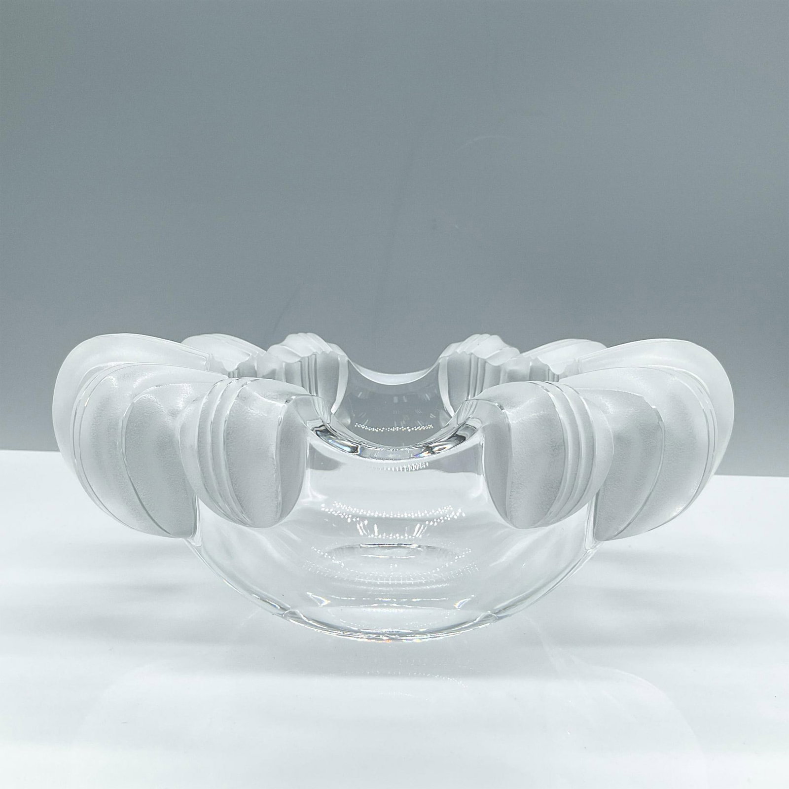 Lalique Crystal Bowl, Athena: Sophisticated clear crystal with frosted relief edges bowl. Lalique signed. Issued: 20th century Dimensions: 4''H x 7.5''dia Manufacturer: Lalique Country of Origin: France