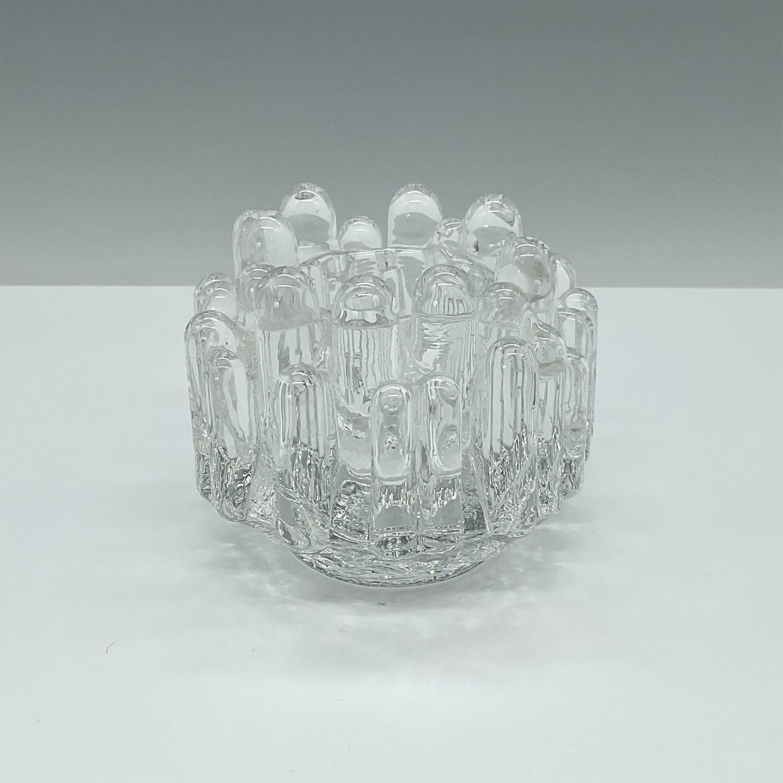 Kosta Boda Votive Candle Holder, Polar: Scandinavian designer Goran Warff's exquisite art glass candle holder captures the essence of modern elegance. Issued: c. 1960 Dimensions: 3.25"H x 4.25" dia. Manufacturer: Kosta Boda Country of Origi