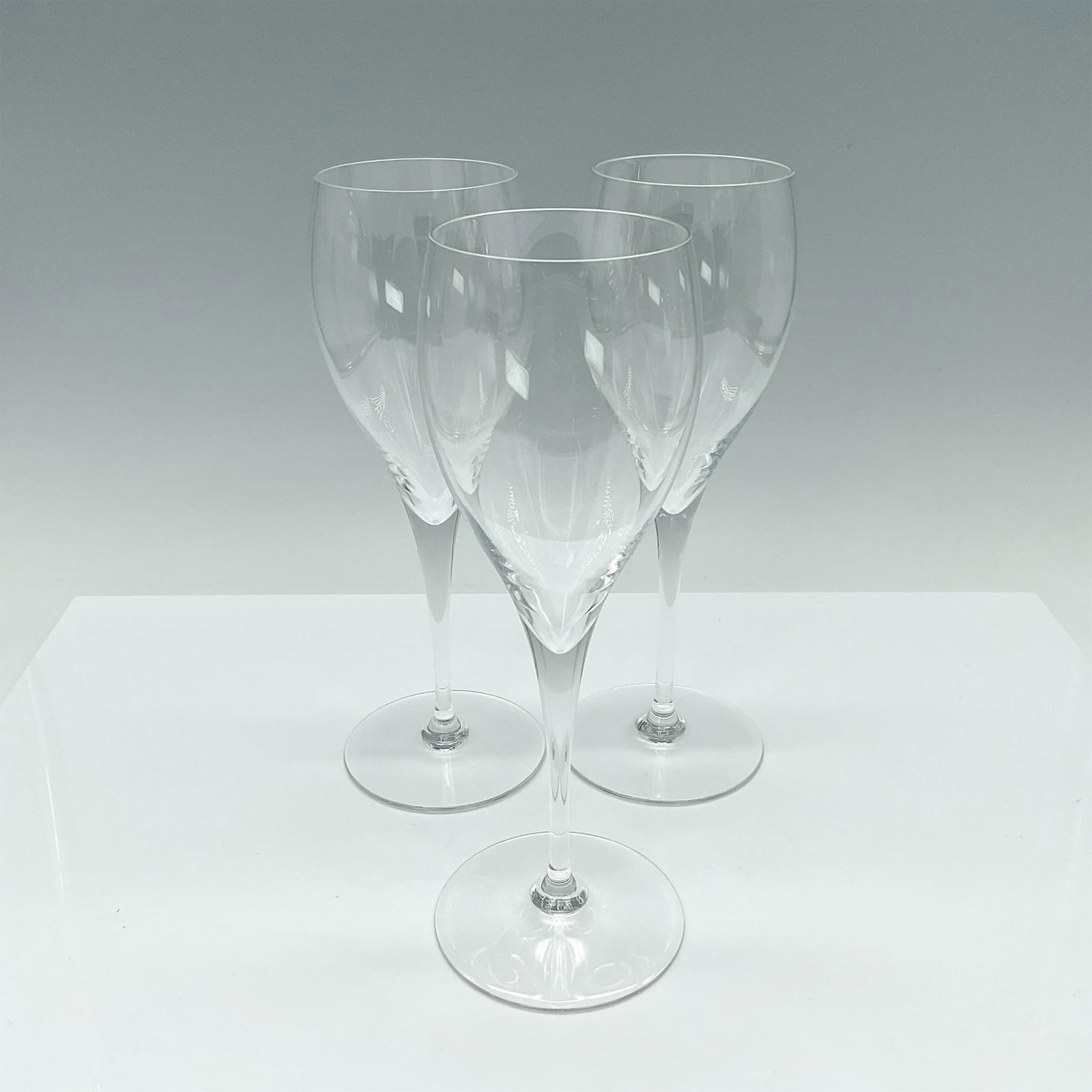 3pc Baccarat Sparkling Wine Glasses: Elegant tulip-shaped glasses designed for sparkling wine, featuring long, narrow bowls and clear, smooth stems. Baccarat acid stamp to base. Dimensions: 3.25"L x 2.5"W x 8.5"H Manufacturer: Baccarat C