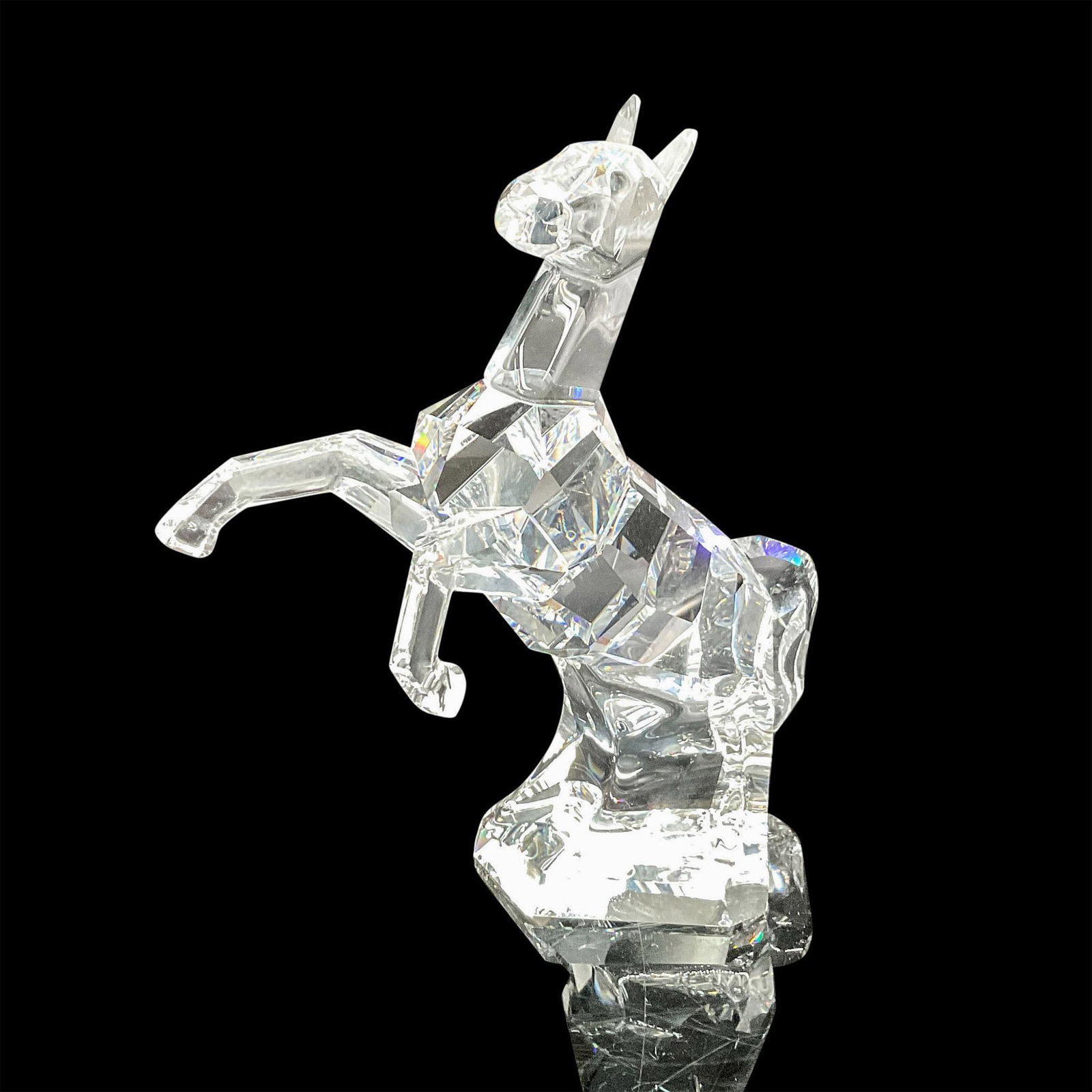 Swarovski Crystal Figurine, The Horse: Bold, rearing clear crystal figure has strong lines of detail. Swarovski backstamp.7685 000 009. This item has its original box: 10"L x 10"W x 5"H. Artist: Mario Dilitz Issued: 20th century Dimensions