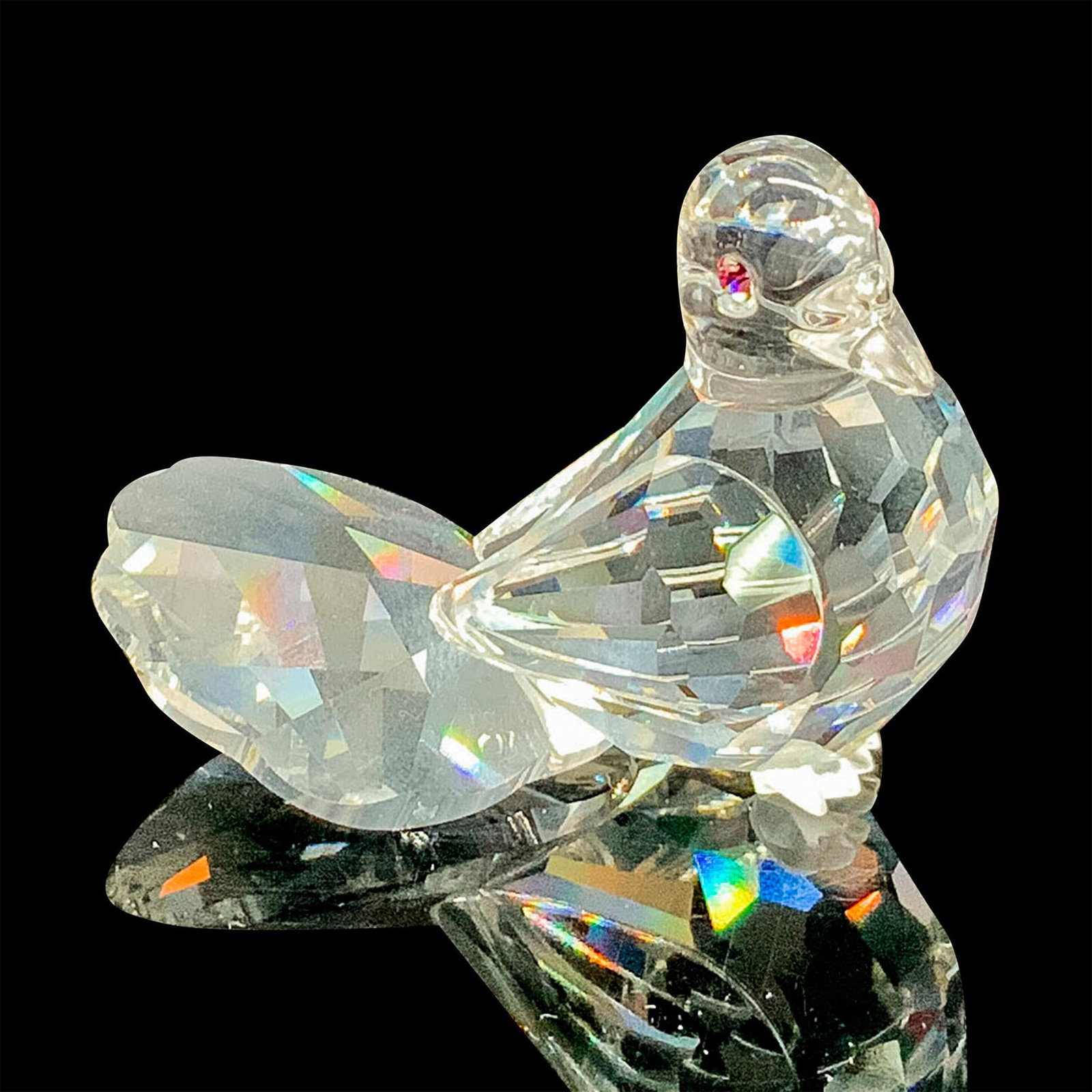Swarovski Silver Crystal Figurine, Dove 191696: This retired Swarovski dove bird figurine has a clear crystal facetted body, a fan shaped tail, frosted feet and pink eyes. Swarovski acid stamp on bottom. The box measures 3.25"dia. x 2.5"H. Artist: 