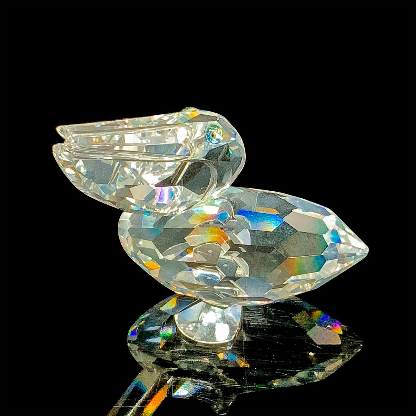 Swarovski Silver Crystal Figurine, Pelican 171899: This retired Swarovski crystal pelican was part of the "Feathered Friends" collection. It is made from clear faceted crystal. Swarovski acid stamp on foot. The box measures 3.25"dia. x 2.5"H. Artist: 