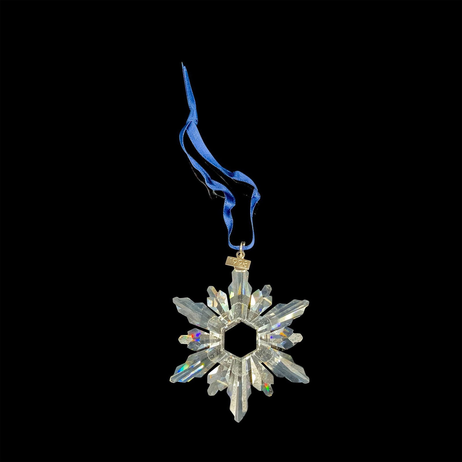 Swarovski Crystal 1998 Annual Christmas Ornament: This retired limited edition Swarovski Christmas tree ornament is made from clear crystal and has 12 points (6 long, 6 short). It also has a metal tag with 1998 etched on it. The box is triangular and
