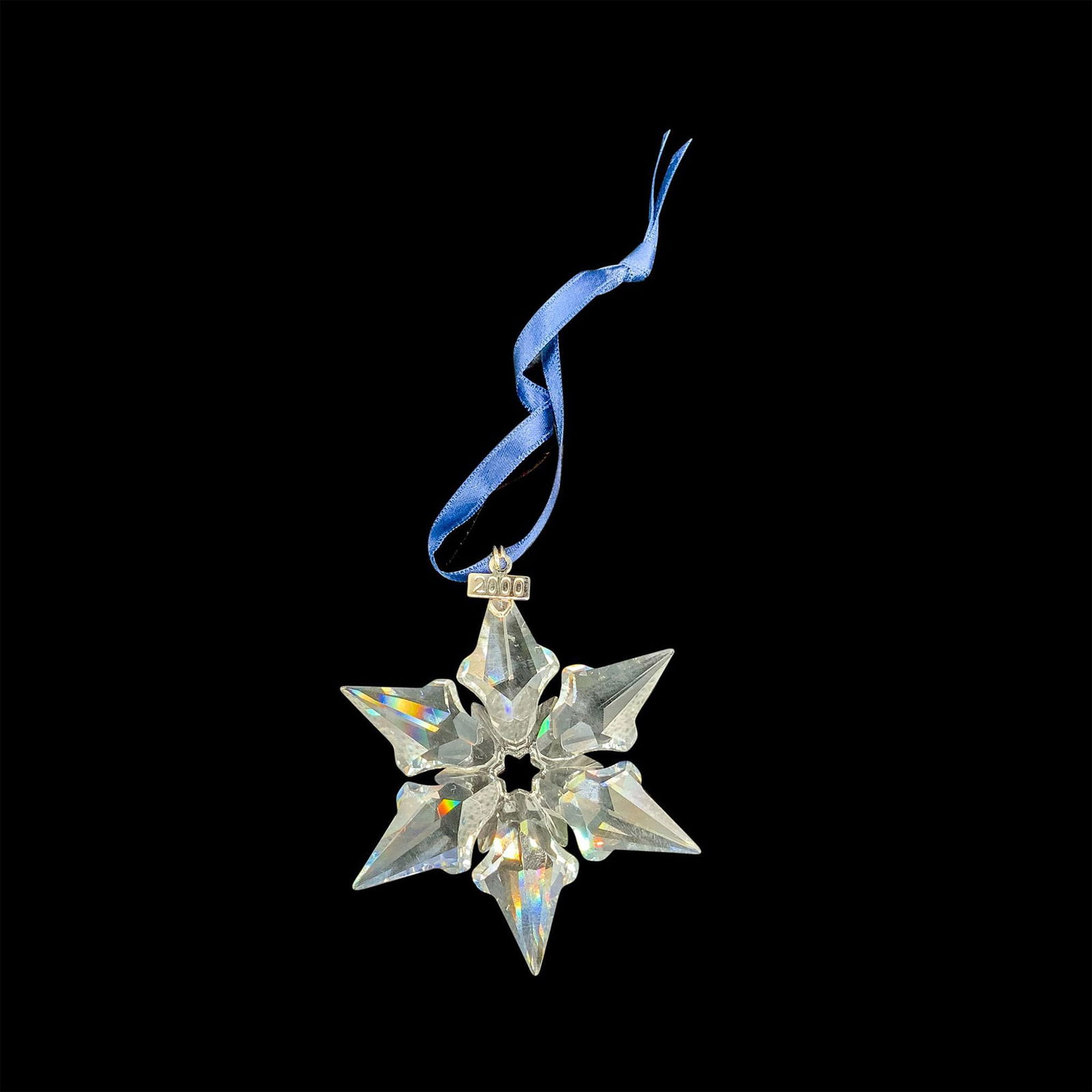 Swarovski Crystal 2000 Annual Christmas Ornament: This retired limited edition Swarovski Christmas tree snowflake ornament is made from clear crystal and has a metal tag with 2000 etched on it. The box is triangular and each side measures 6.5"L x 1.2