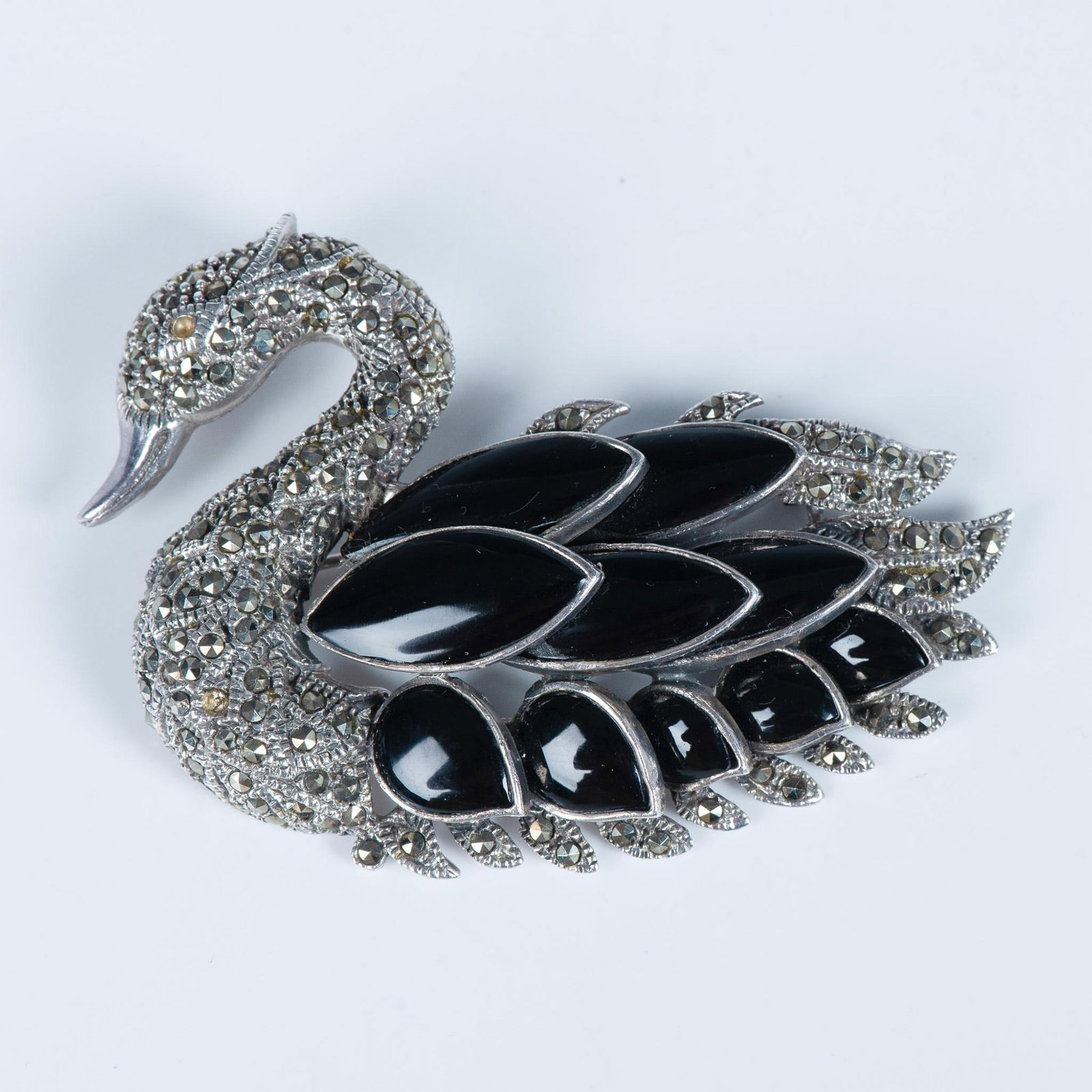 Sterling Silver Marcasite and Onyx Swan Brooch: Fabulous sterling silver marcasite brooch with larger feather shape onyx stones. Missing one marcasite in the neck and the eye which gives you the chance to make it your own with any color eye. Backst