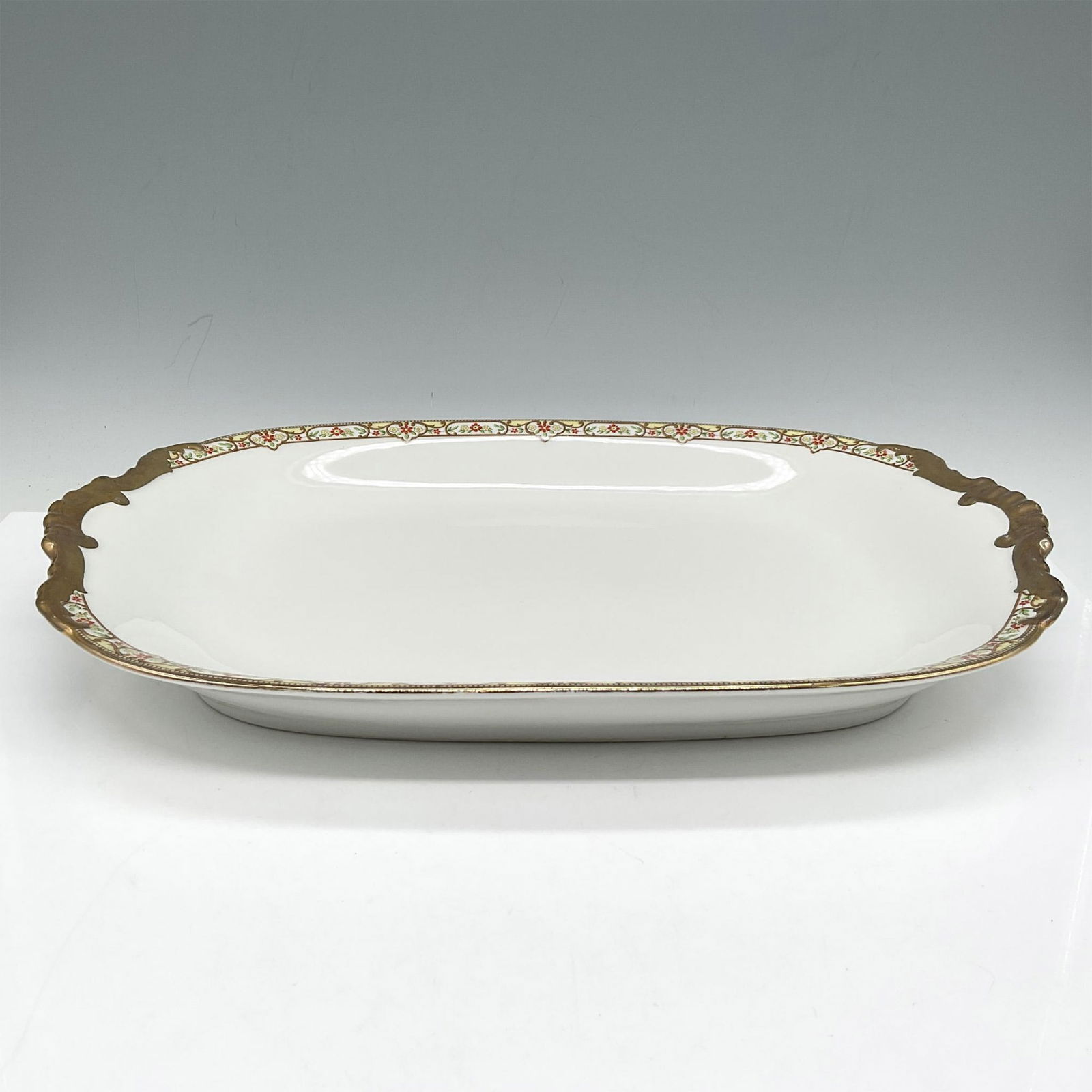 Limoges Vignaud Porcelain Serveware, Medium Oval Platter: Elegant gilt banded design of red and yellow floral pattern on platter. Limoges Vignaud France Loeser's backstamp. VIG167. Issued: c. 1911 - 1938 Dimensions: 14"L x 10"W x 1.75"H Manufacturer: Limoges