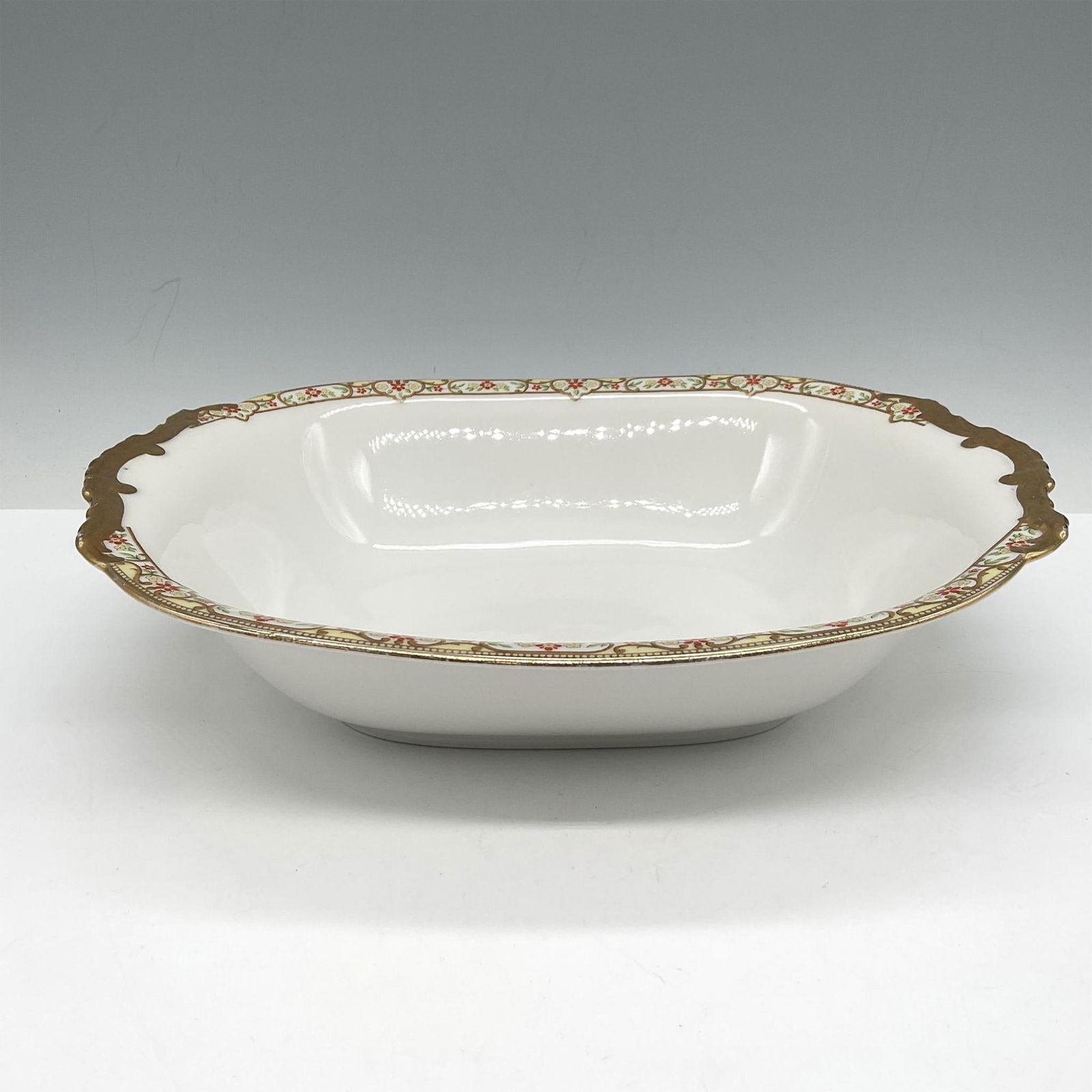 Limoges Vignaud Porcelain Serveware, Oval Vegetable Dish: Lovely gilt banded design of red and yellow floral pattern on rim of bowl. Limoges Vignaud Loeser's backstamp. VIG167. Issued: c. 1911 - 1938 Dimensions: 10.5"L x 8"W x 2.25"H Manufacturer: Limoges Vi