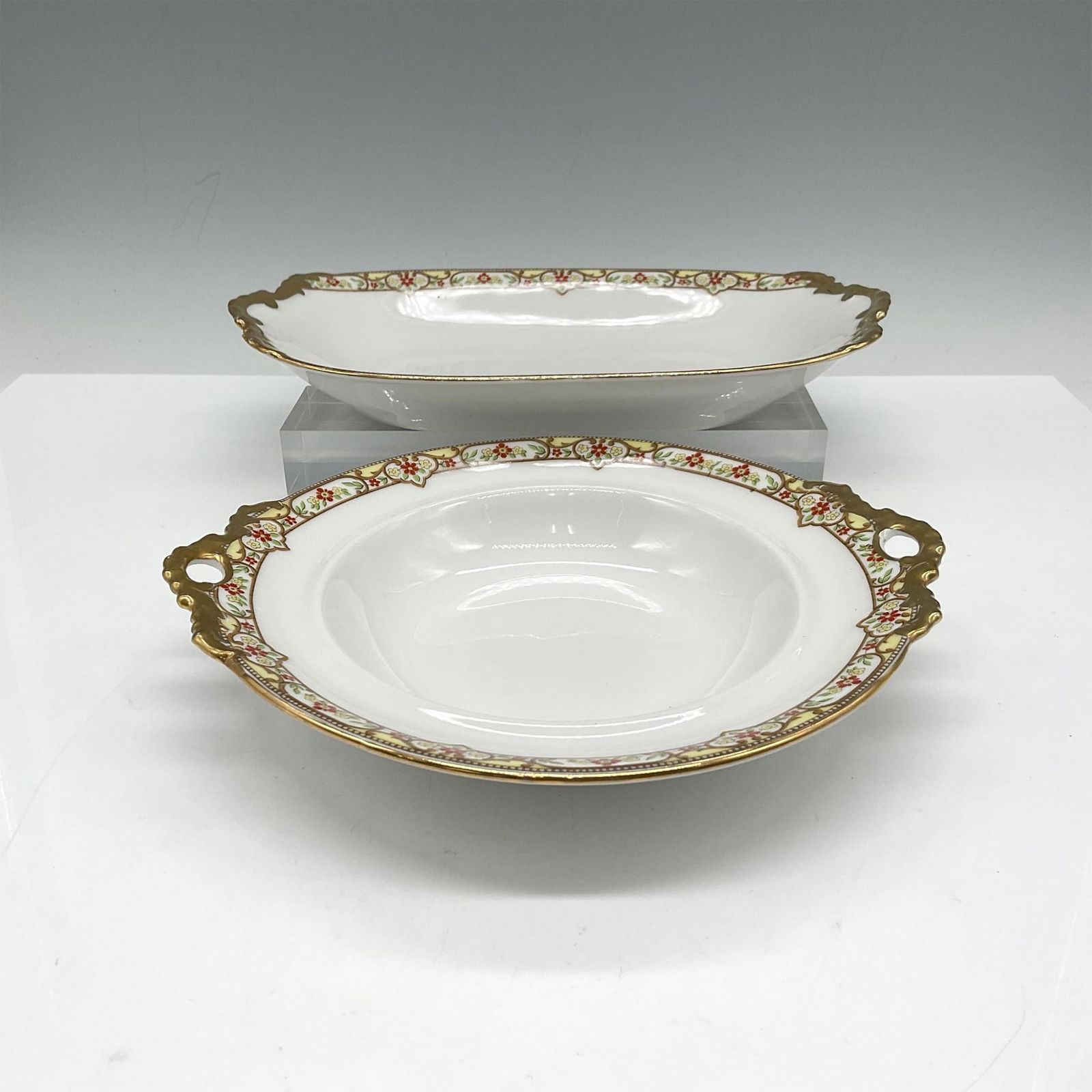 2pc Limoges Vignaud Porcelain Serveware, Side Dishes: Lovely serveware features an elegant design of a red and yellow floral band on white, accentuated by gilt trim. Set includes relish dish 9" and round handled dish 7". Limoges Vignaud Loeser's backstam