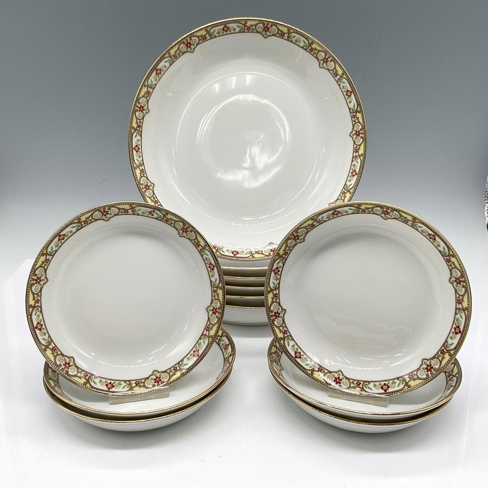 12pc Limoges Vignaud Porcelain Serveware, Bowls: Elegant design of red and yellow floral band on white, accentuated by gilt trim. Set includes 6 bowls 7.5" and 6 fruit bowls 5". Limoges Vignaud Loeser's backstamp. VIG167. Largest piece: 1.5"H x 7.5"