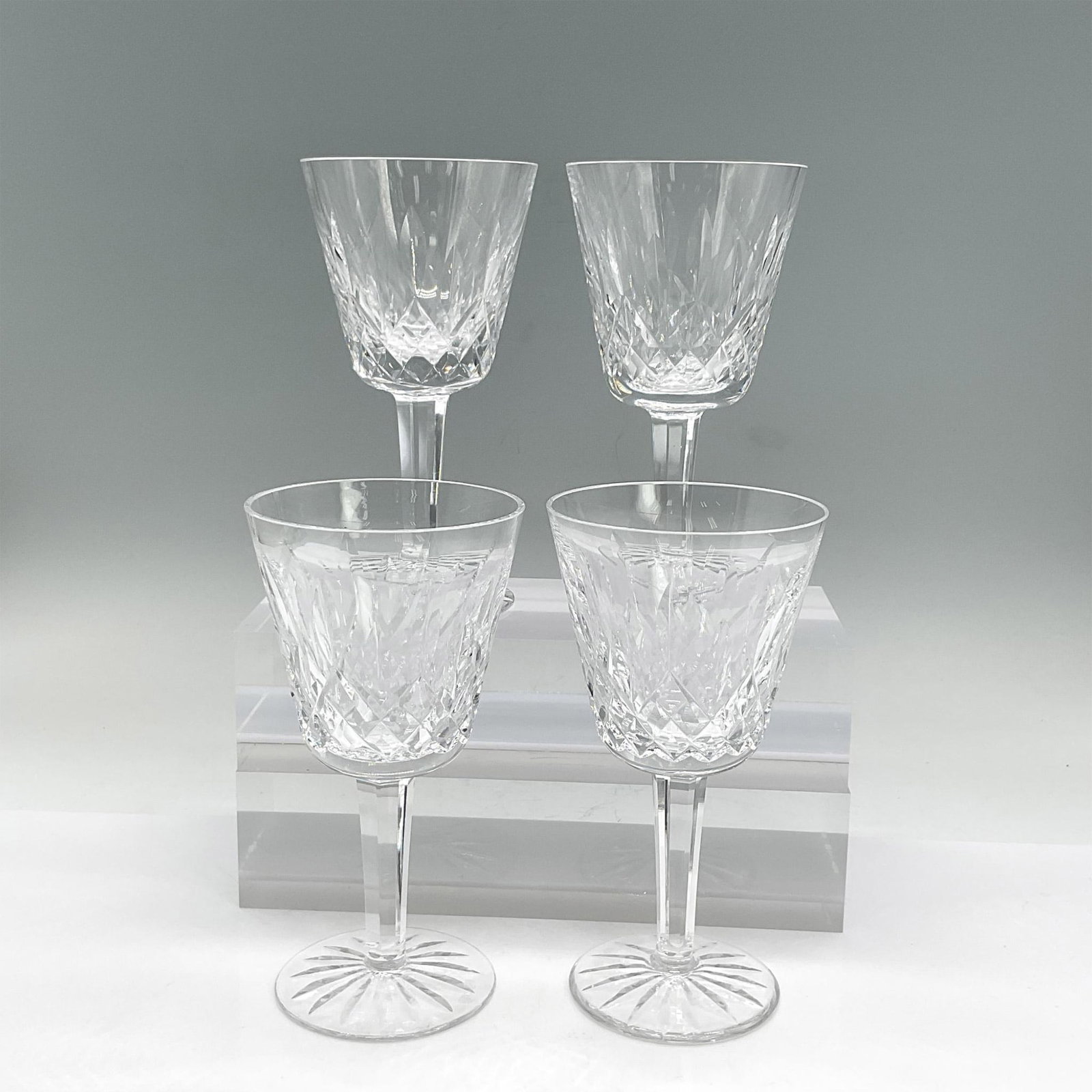 4pc Waterford Crystal Wine Glasses, Lismore: Four clear stemmed crystal glasses with crisscross, leaf and sunburst etched design. Waterford mark. Dimensions: 5.75"H x 3" dia Manufacturer: Waterford Country of Origin: Ireland