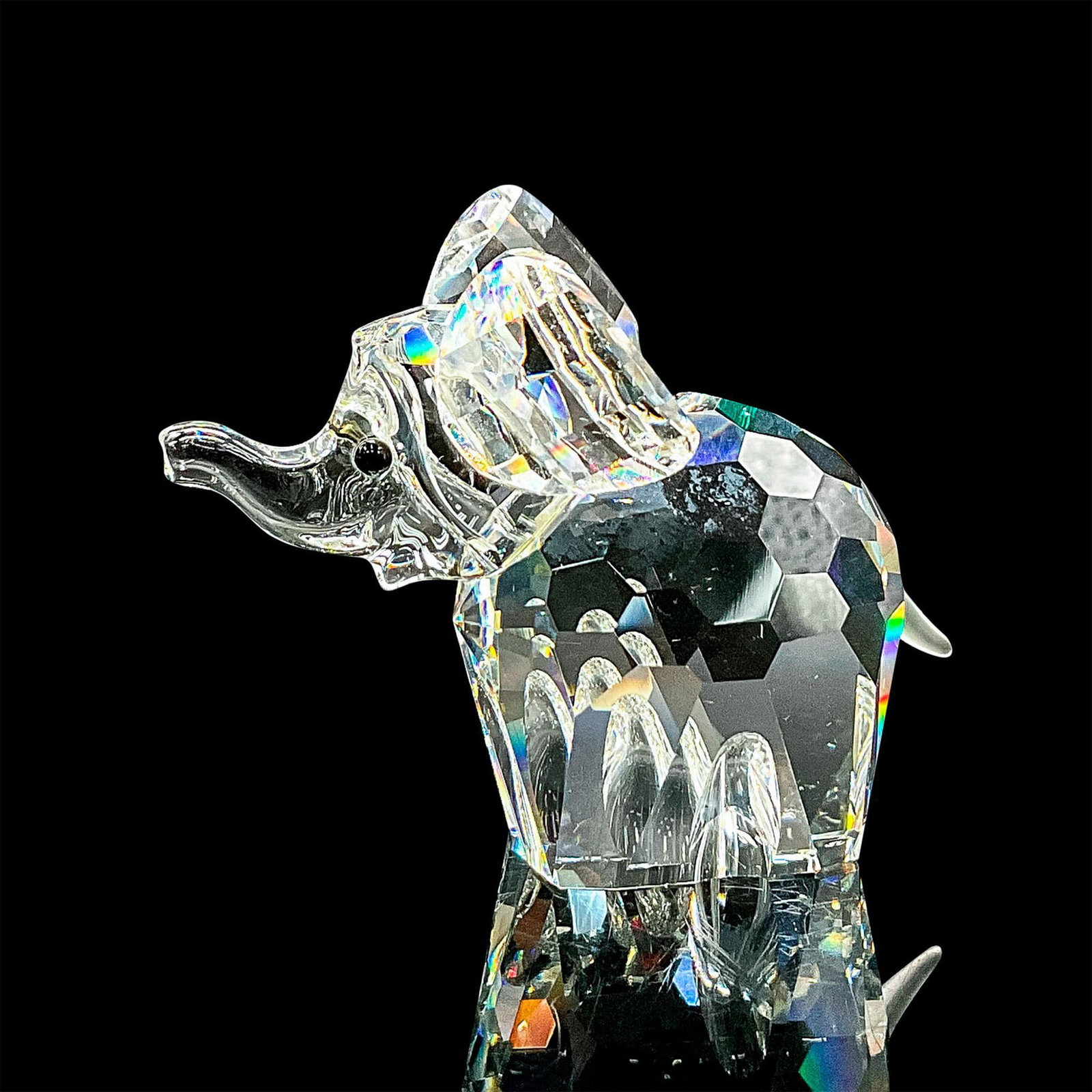 Swarovski Silver Crystal Figurine, Elephant: Clear faceted crystal figure of an elephant with black eyes and frosted tail. Item number 7640NR060000. Retired; part of the African Wildlife collection. Swarovski mark. This item has its original box