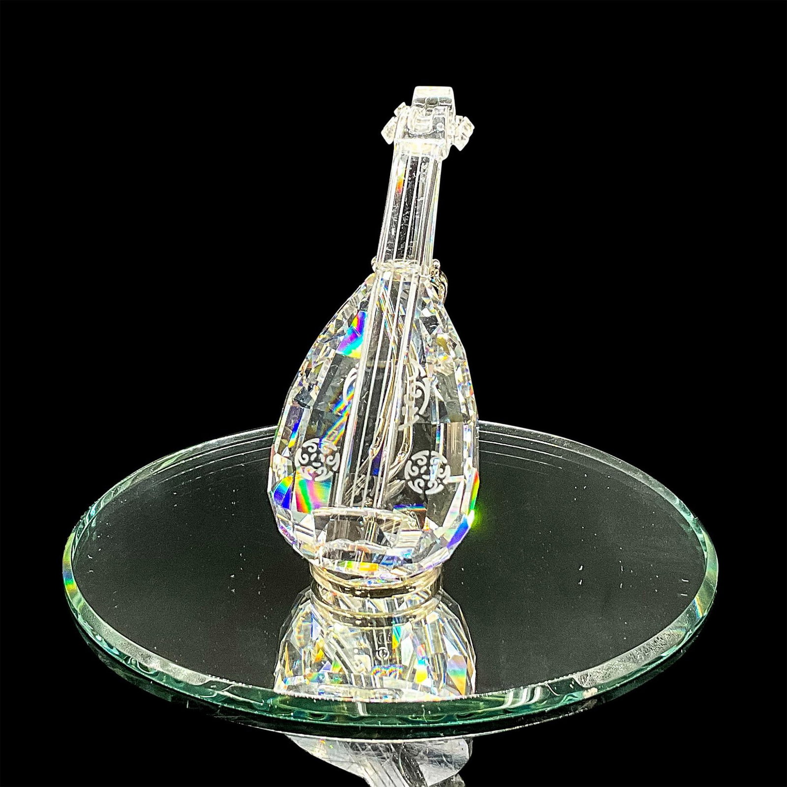 Swarovski Silver Crystal Figurine, Lute on Stand + Mirror: Clear faceted crystal figure of a lute with Celtic style etched design. Retired. Swarovski mark. Item number 7477NR000004. Part of the Crystal Melodies collection. This item has its original box: 6"H 