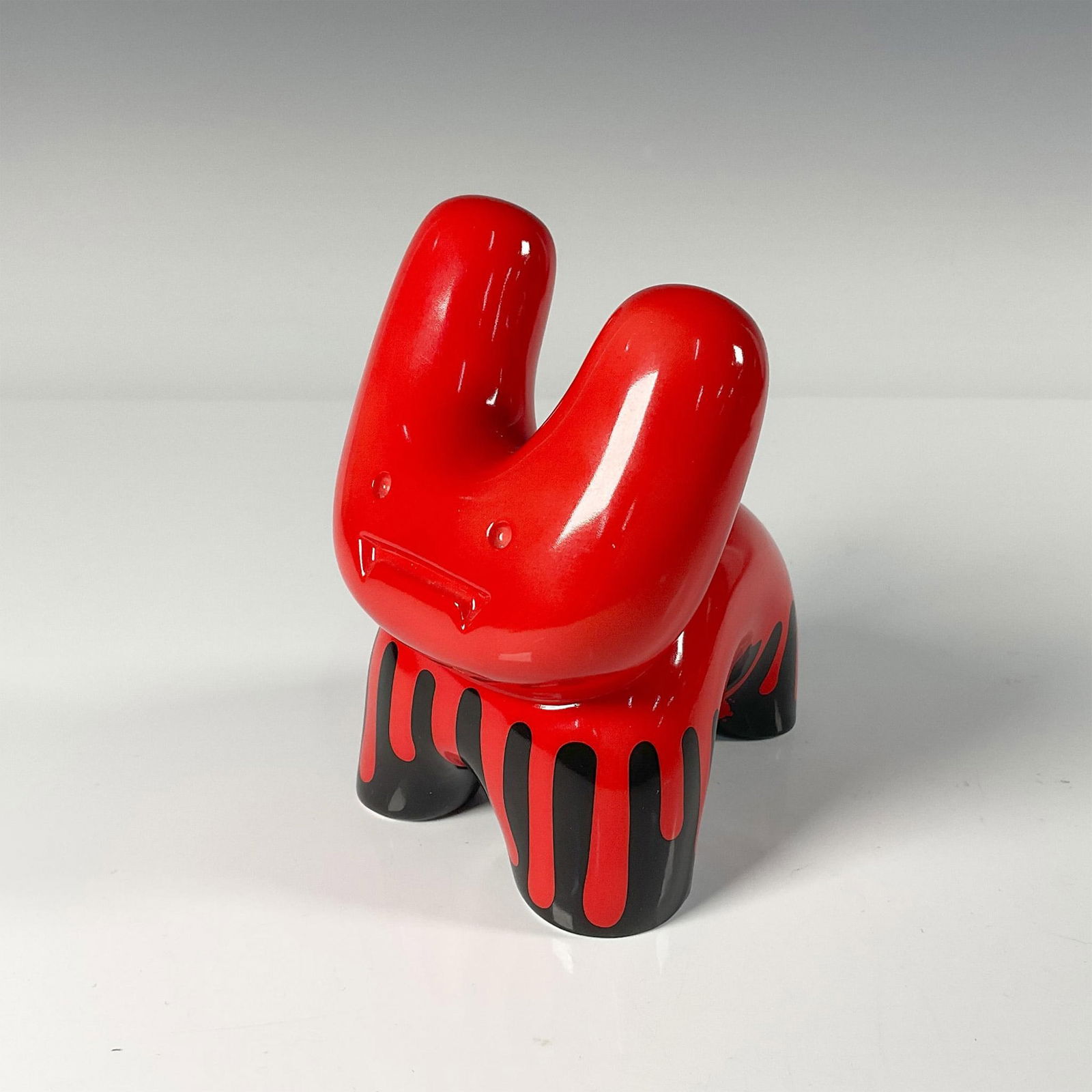 Pure Evil - Royal Doulton Figurine: Limited edition number 296, modern form in red dipped and dripped. Gloss finish. Royal Doulton backstamp in black. Issued: 21st century Dimensions: 4.75"L x 3.75"W x 5.5"H Manufacturer: Royal Doulton
