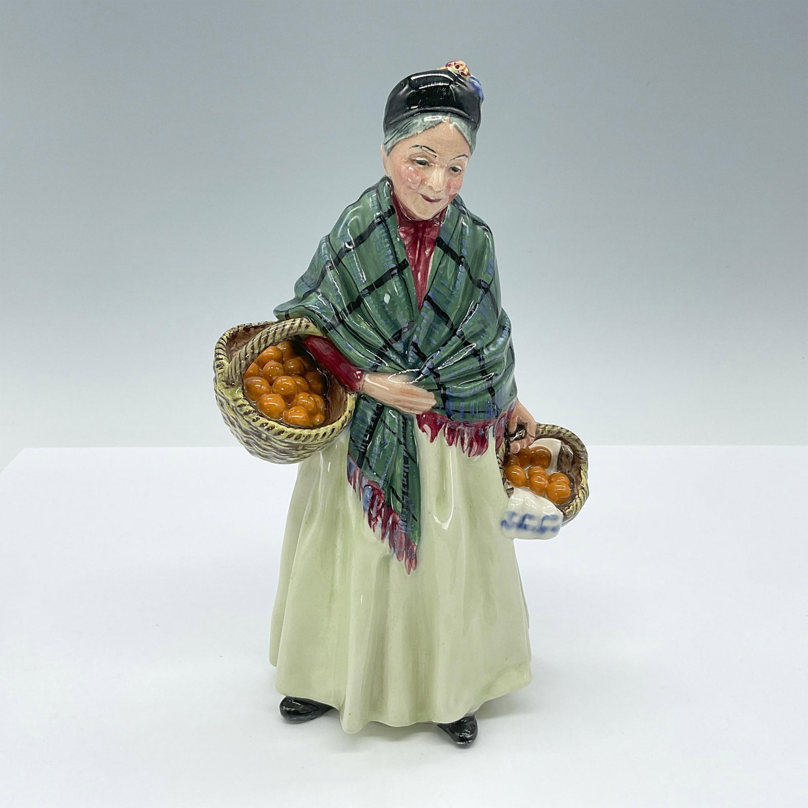Orange Lady - HN1953 - Royal Doulton Figurine: Artist: Leslie Harradine Issued: 1940 - 1975 Dimensions: 8.5"H Manufacturer: Royal Doulton Country of Origin: England