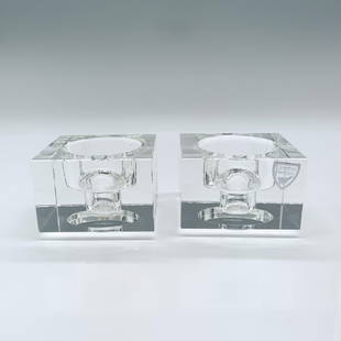 Pair of Orrefors Crystal Totem Balance Candle Holders: Beautiful candle holders designed by Karim Rashid. They come in their original box which measures 6"L x 3.75"W x 2.75"H. Artist: Karim Rashid Dimensions: 2.25"L x 2.25"W x 1.5"H Manufacturer: