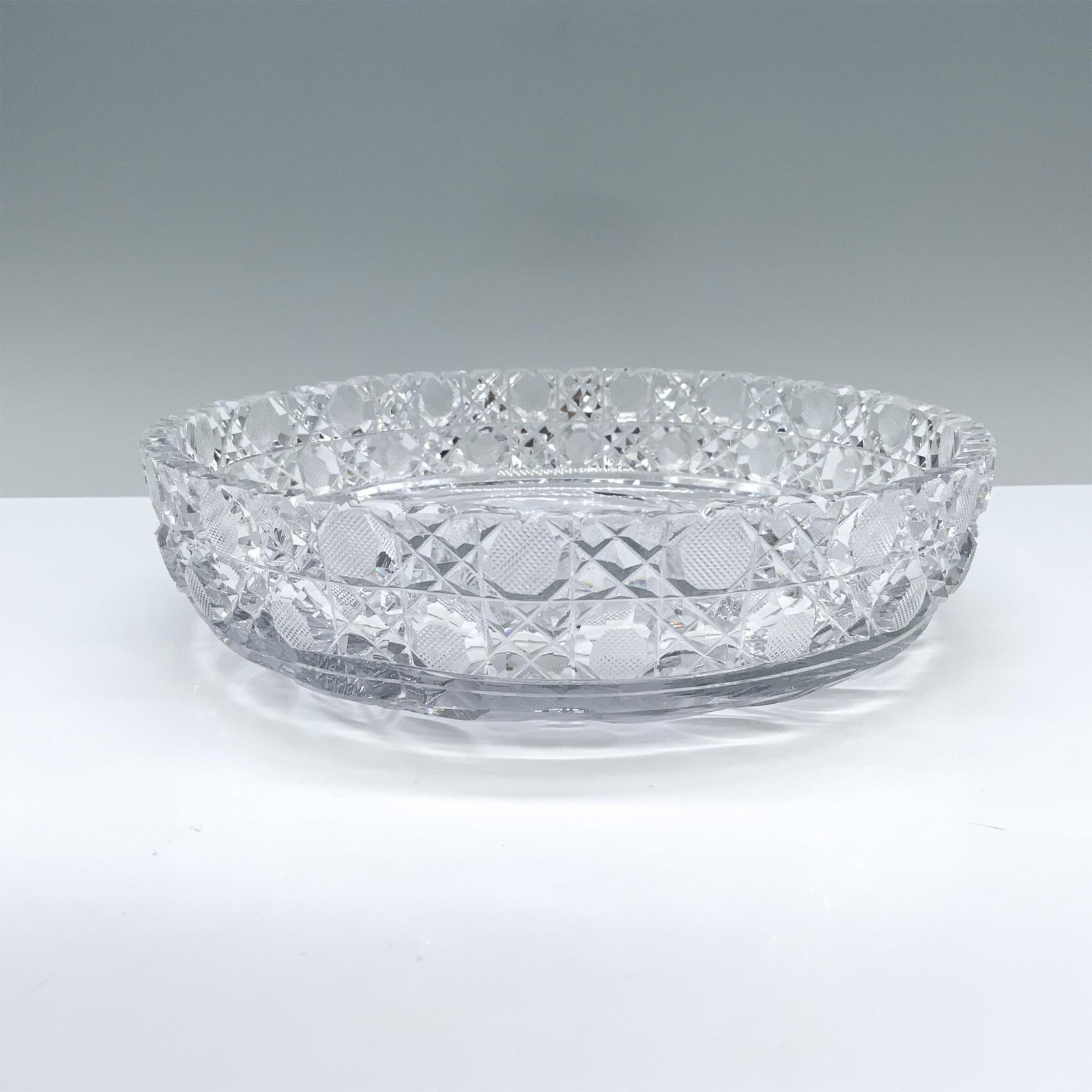 Crystal Floral Themed Serving Bowl: Designed with an abstract rim and charming daisies and palm leaves etched at its base. Dimensions: 2"H x 8" dia.