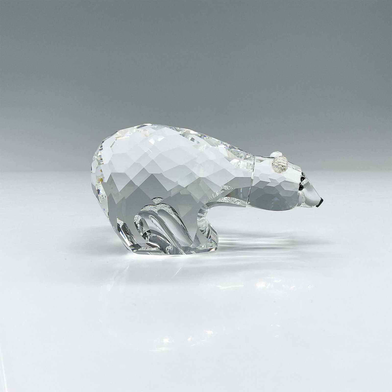 Swarovski Crystal Figurine, Polar Bear: Part of the Kingdom of Ice and Snow series, this bear was faceted from clear crystal with jet black eyes and nose. Swarovski etched backstamp. This item has its original box. box dimensions: 4.25"H x 