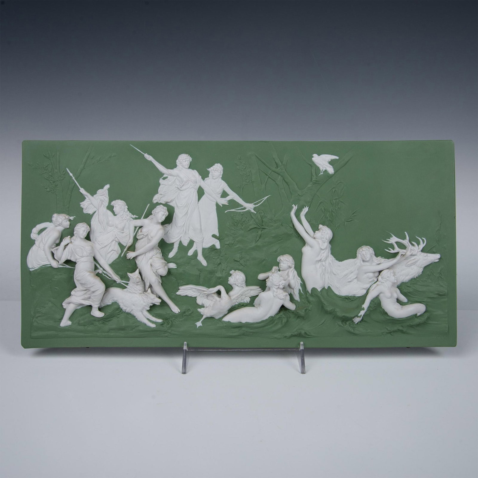 Neoclassical Sage Green Wall Plaque, Battle In The Forest: Sage green stoneware wall plaque with sprigged images of nude ladies in the water besieged by a spear-wielding group, in high-relief. In the style of Wedgwood Jasperware. Signed on upper right corner.