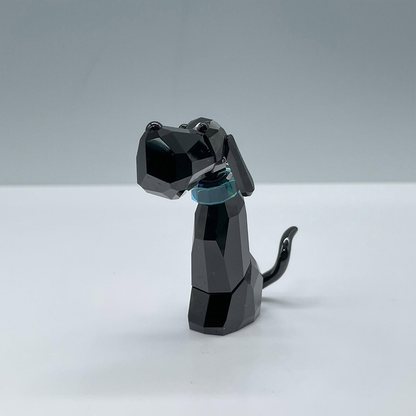 Swarovski Crystal Figurine, Salvatore: Black crystal with blue collar from The Gang of Dogs collection. Includes certificate and the original box, dimensions: 4.25''H x 3.25''dia. Swarovski etched backstamp. Issued: 20th century Dimensions