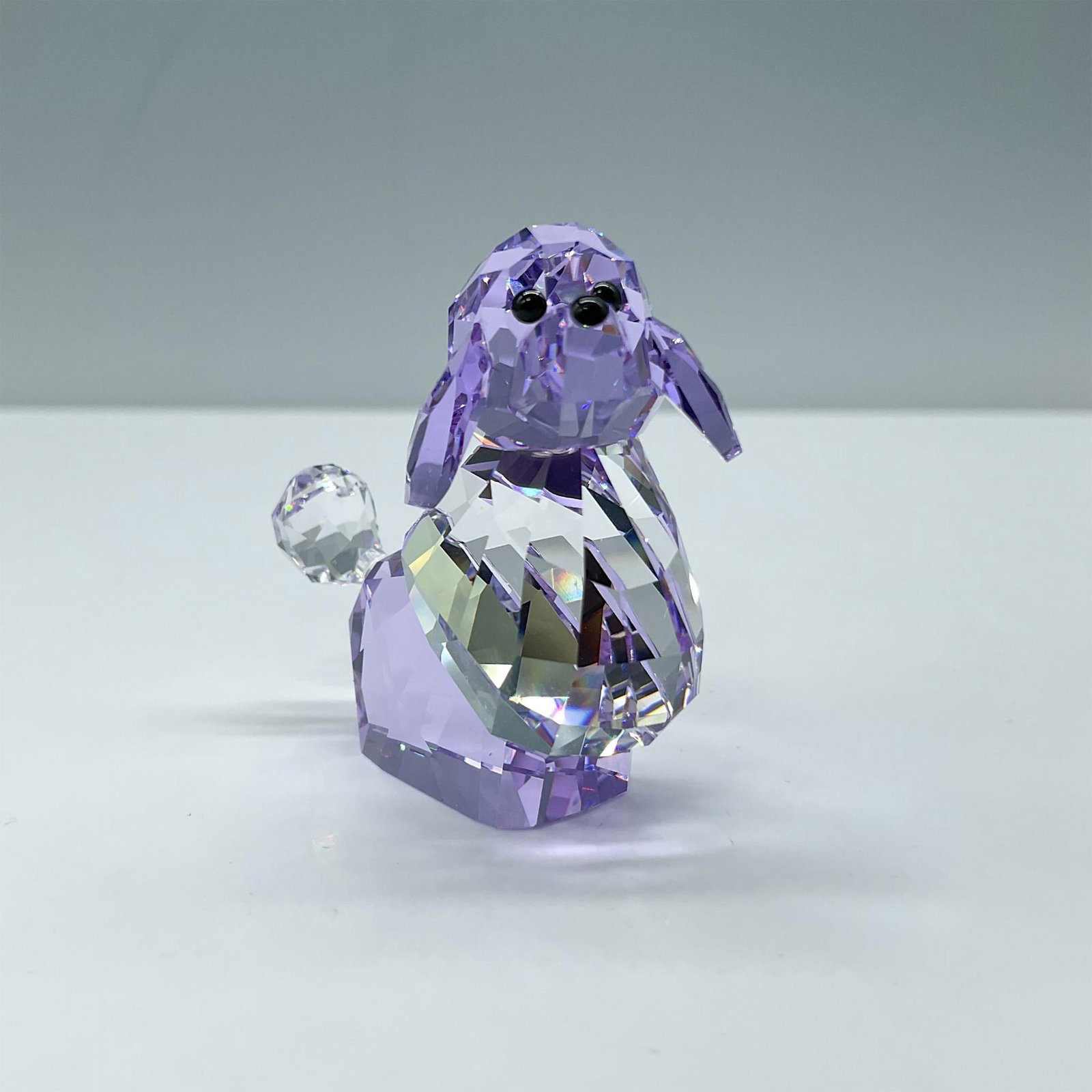 Swarovski Crystal Figurine, Violetta the Poodle: Limited edition clear and purple colored crystal poodle from The Gang of Dogs collection. Includes certificate and the original box, dimensions: 4.75''H x 3.25''dia. Swarovski etched backstamp. Issued