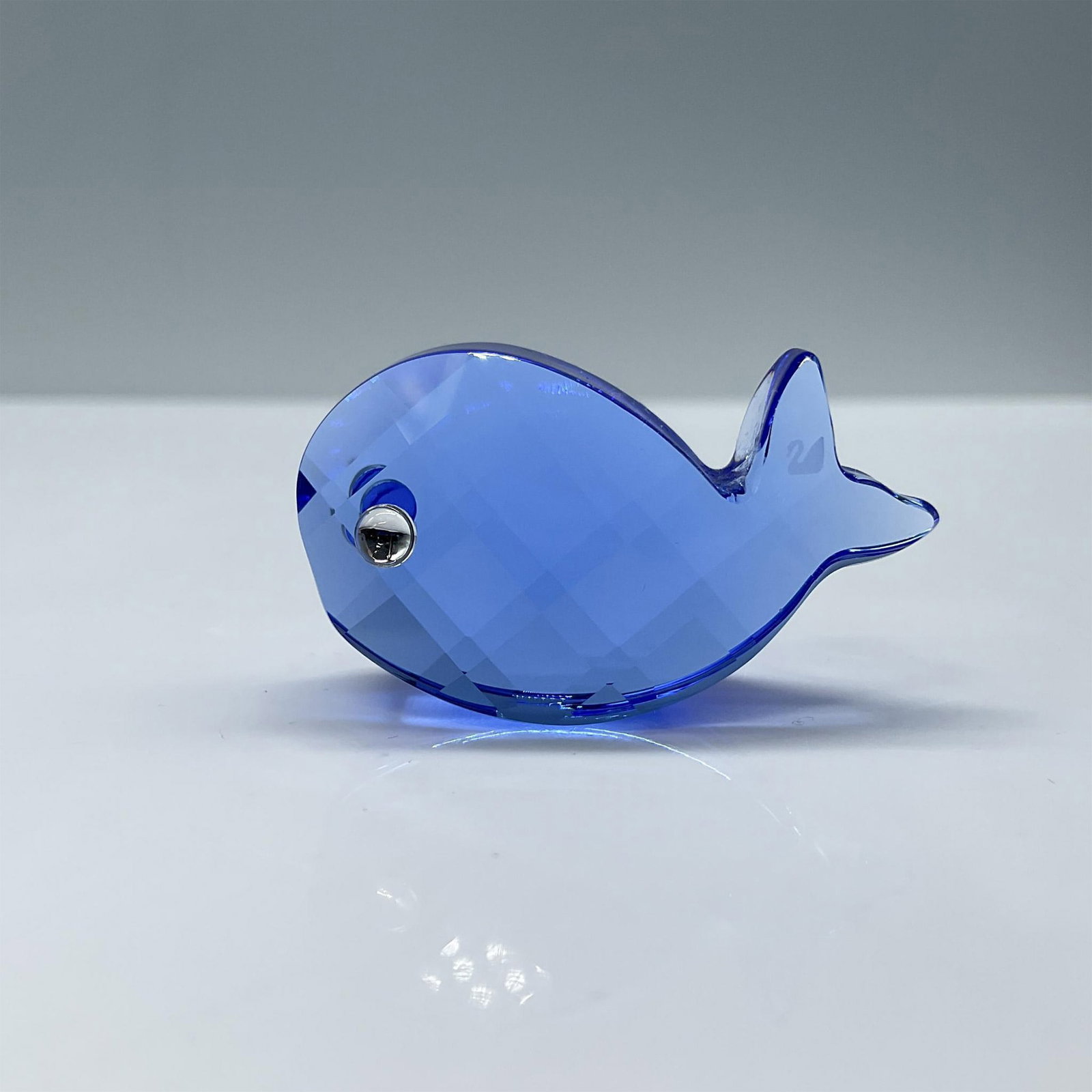 Swarovski Crystal Figurine, Walter the Whale: Retired blue crystal miniature whale, part of the Little Companions collection. Includes certificate and the original box, dimensions: 3"L x 3"W x 1.5"H. Swarovski etched backstamp. Artist: Mario Dili
