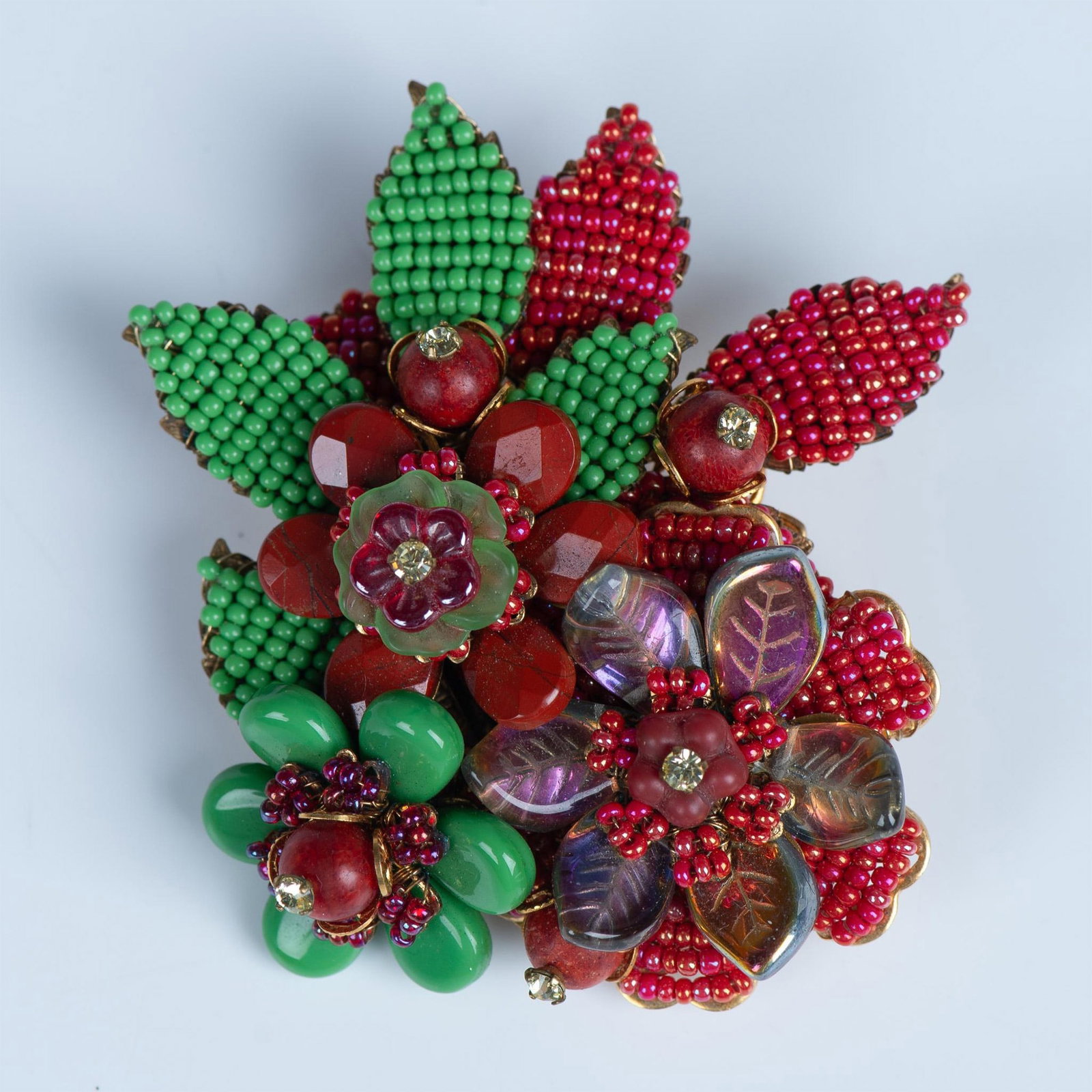 Rare Large Stanley Hagler NYC Floral Brooch: Gorgeous goldtone pin featuring flowers and leaves with red, green and iridescent beads and rhinestones. Stanley Hagler NYC stamp on the back. Dimensions: 2.75"L x 3"W Manufacturer: Stanley Hagler Cou