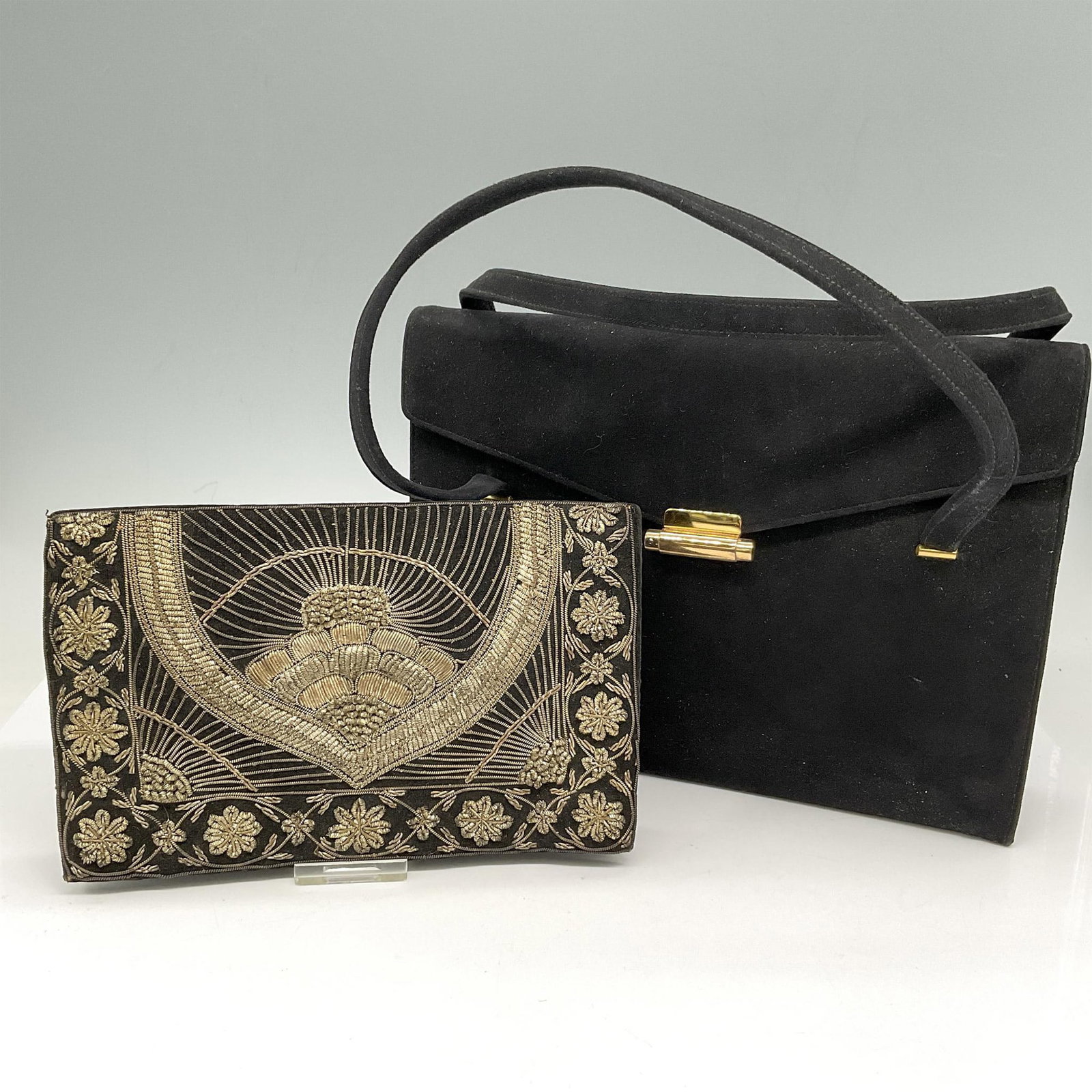 2pc Perma Suede Handbag and Clutch: Beaded clutch on black suede with snap front closure and hand strap. Made in India. Black suede with double handle and gold tone tab closure opens to interior pockets. Coblentz original embossed mark.