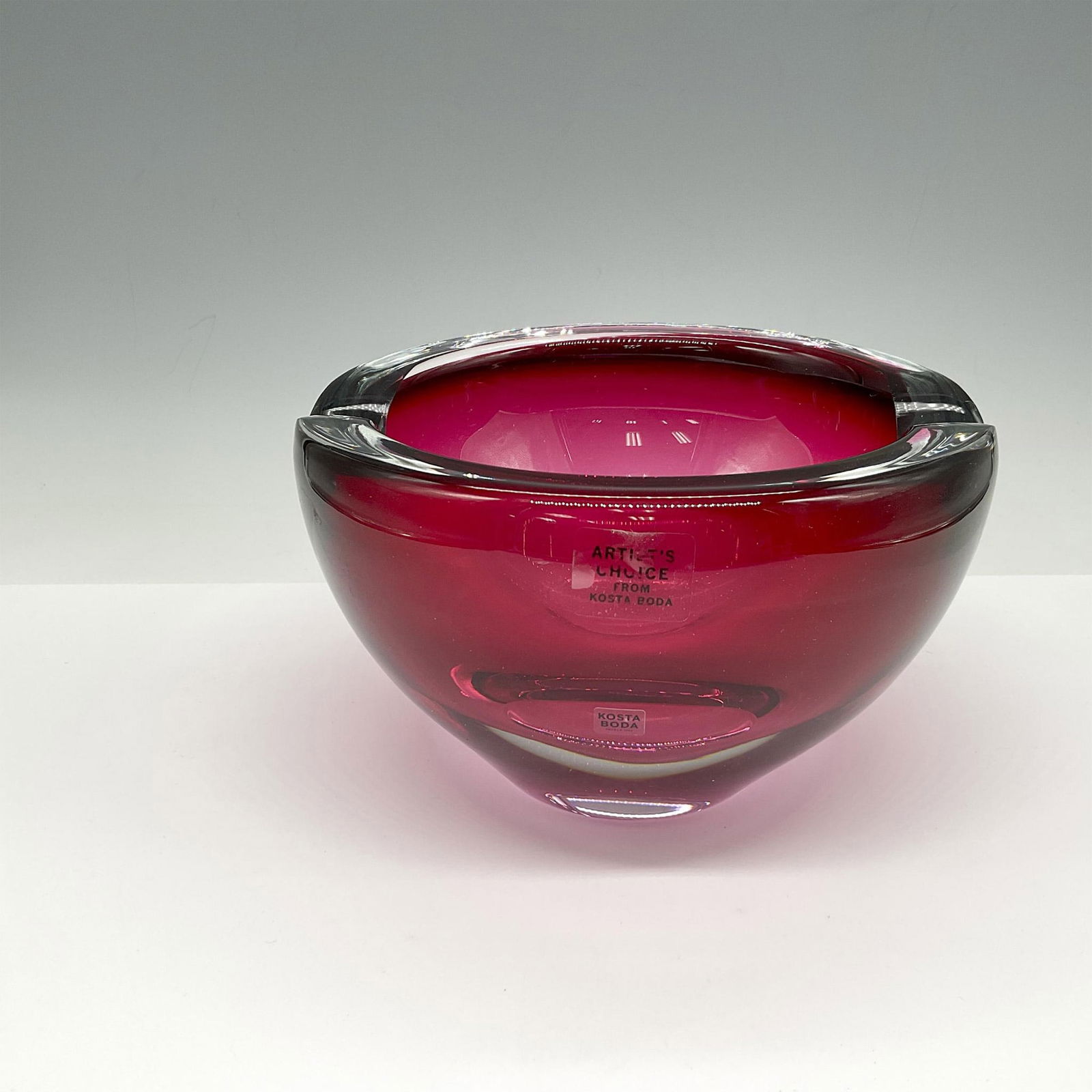 Goran Warff for Kosta Boda Art Glass Bowl, Raspberry: Lovely crystal bowl marked Artist's Choice has dimples rim with deep concave center. Signed by artist. Kosta Boda mark. Artist: Goran Warff Issued: 21st century Dimensions: 7"L x 6.5"W x 4.5"H Manufac
