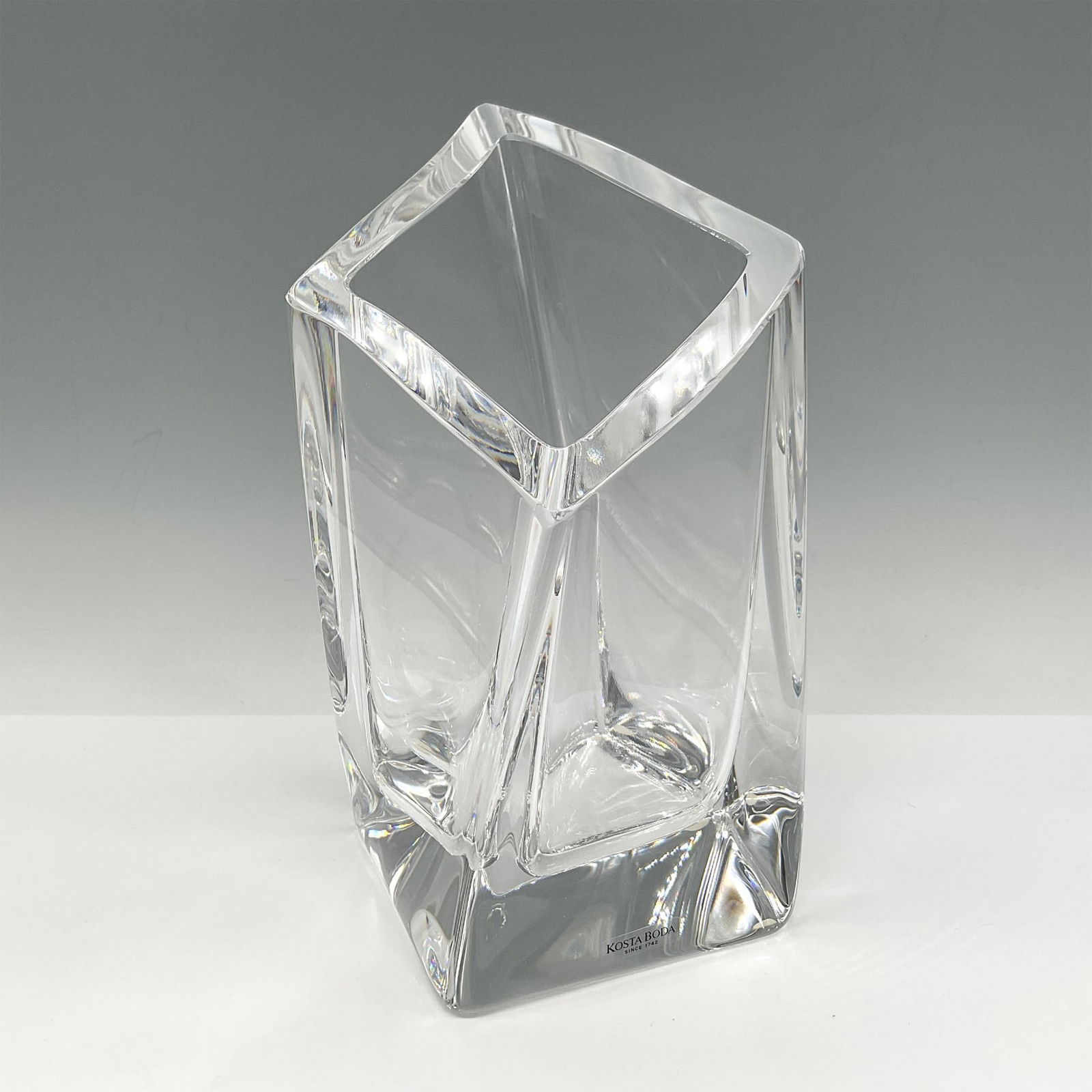 Goran Warff for Kosta Boda Crystal Vase: Thick-walled crystal with angled edges. Signed by artist. Kosta Boda mark. Artist: Goran Warff Issued: 21st century Dimensions: 4"L x 4"W x 8"H Manufacturer: Kosta Boda Country of Origin: Sweden<