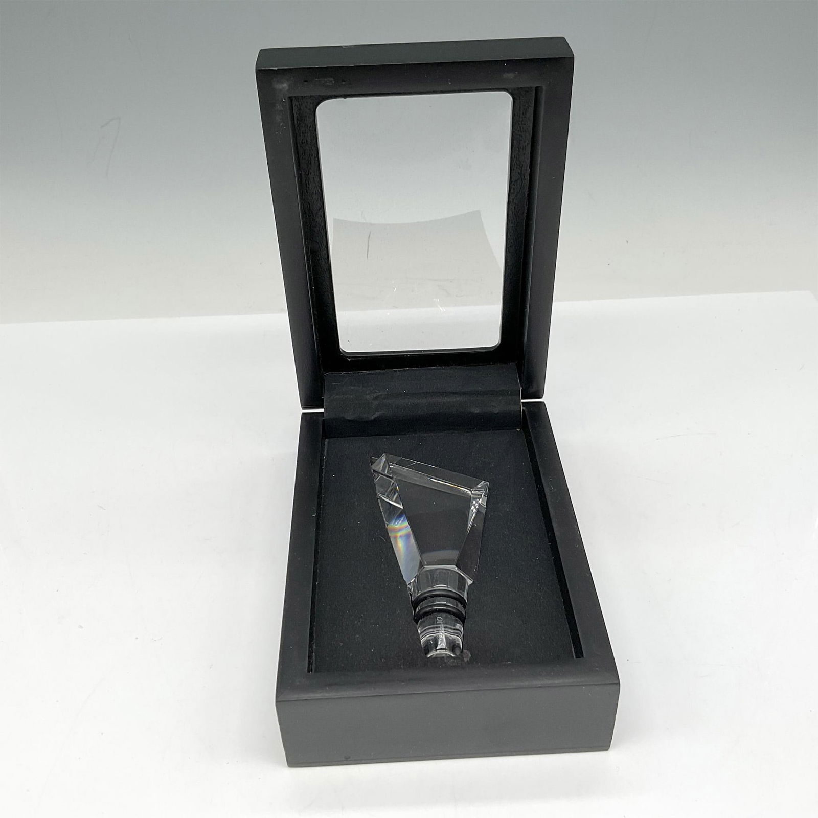 Orrefors Crystal Carat City Bottle Stopper, Stockholm: Clear crystal angled stopper created to mimic metropolises around the world. Stopper is created with rubber bottom to fit most wine and liquor bottles. Orrefors mark. This item has its original box: 4