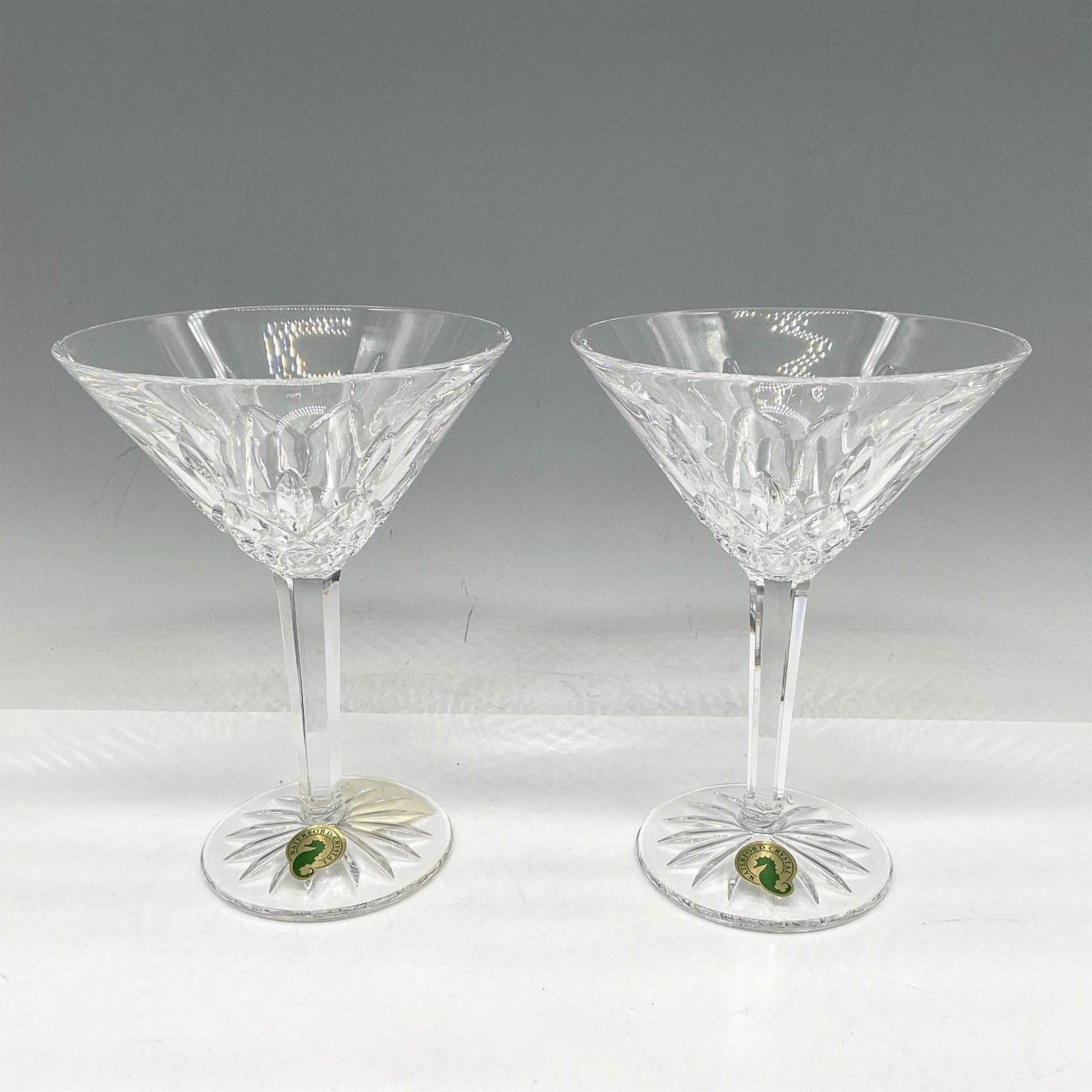 Pair of Waterford Crystal Martini Glasses, Lismore: Lismore pattern, created in 1953, was influenced by the 18th Century Crystal designs of the Waterford Founders George and William Pen Rose and designer, Miroslav Havel. The clean crystal lines with cu