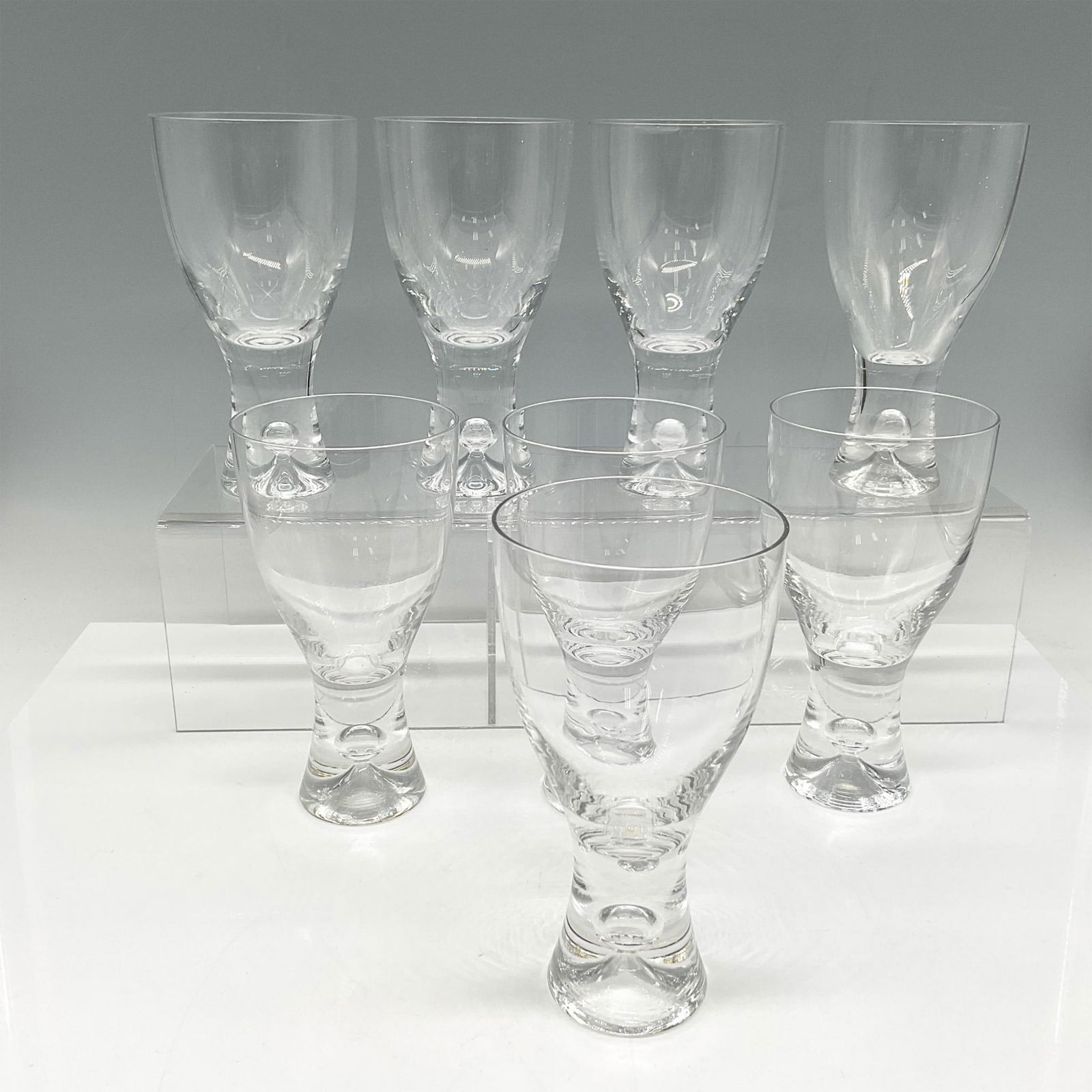8pc Iittala Tapio Wine Glasses: Clear body with weighted base. Issued: 20th century Dimensions: 5.75"H x 3" dia. Manufacturer: littala Country of Origin: Finland