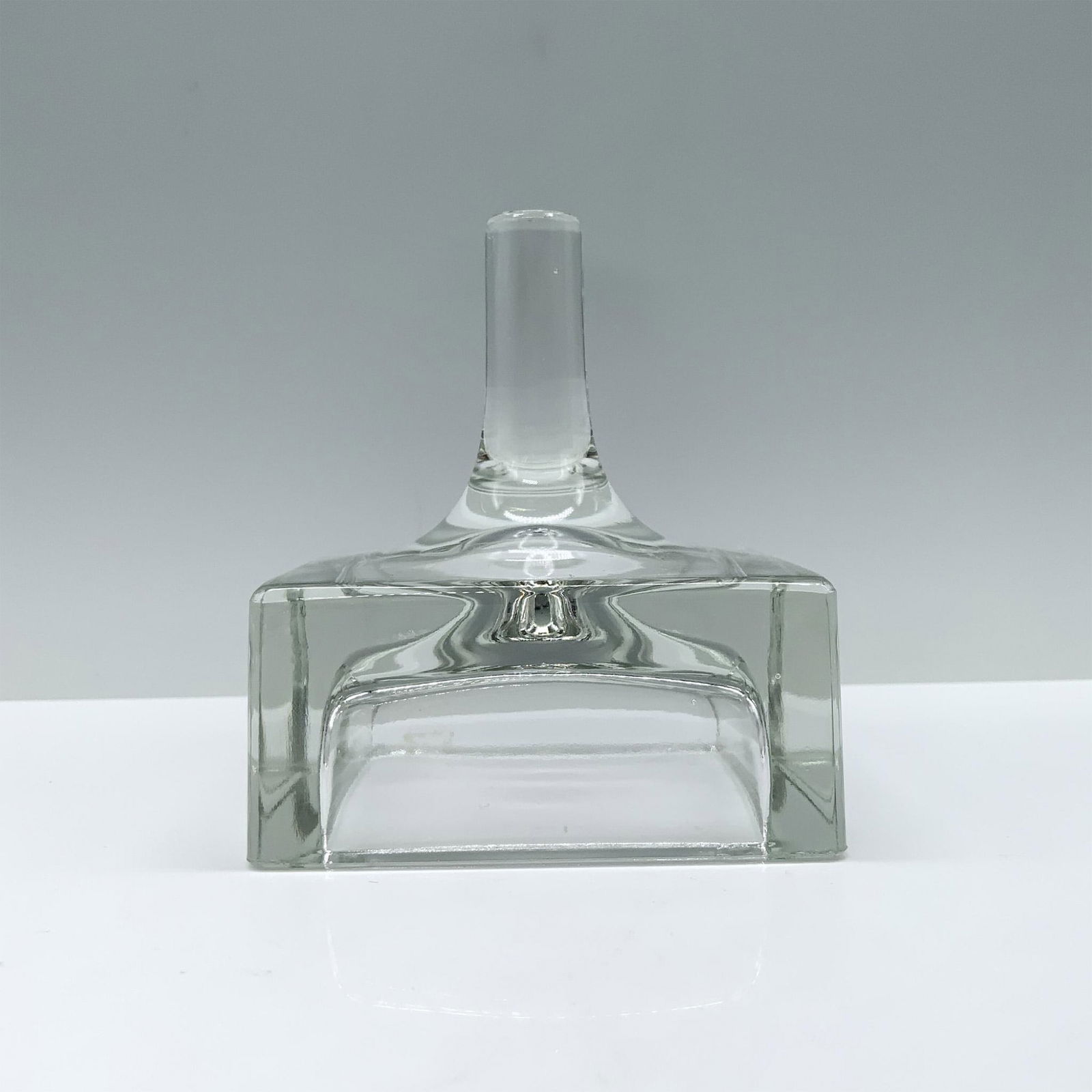 Dansk Crystal Ring Holder: A sleek clear ring holder featuring a stump design atop a flat, hollow square base. Dimensions: 3.5"L x 3.5"W x 4"H Manufacturer: Dansk