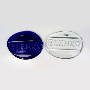 2pc Vintage Blenko Glass Plaques: 2 oval handmade solid blown glass plaques with the BLENKO logo. Blenko stickers. Clear: 12"L x 0.75"W x 8.5"H. Blue: 11.75"L x 1"W x 8.75"H. Manufacturer: Blenko Glass Company Country of Origin: