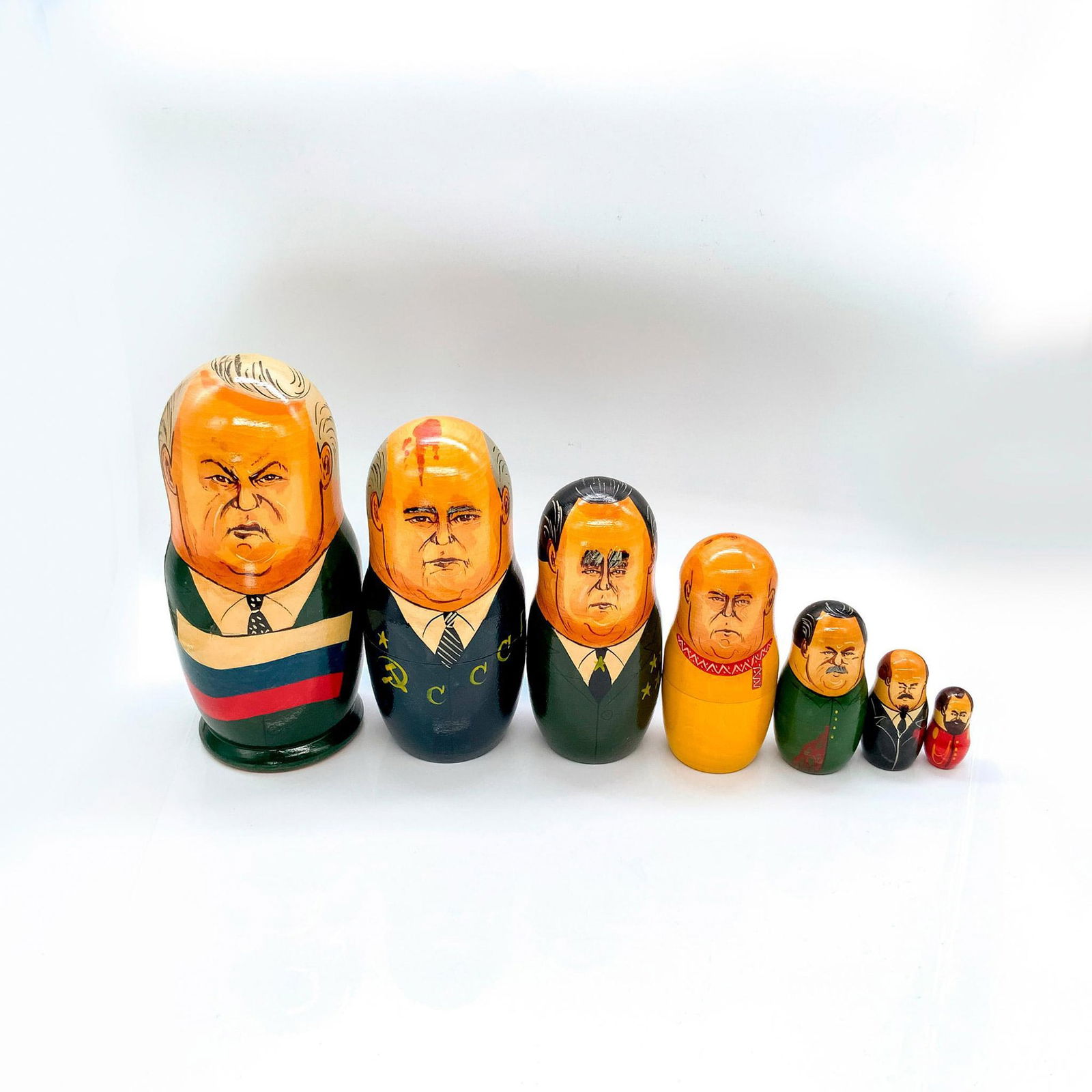 7pc Russian Nesting Dolls Set, Political Leaders: Depicts in various sizes Russian politicians such as: Lenin, Stalin, Czar Nicholas, Gorbachev, Khrushchev, Brezhnev, and Yeltsin. Dimensions of largest: 3.5 in. L x 3.5 in W x 8.75 in. H. Country of O