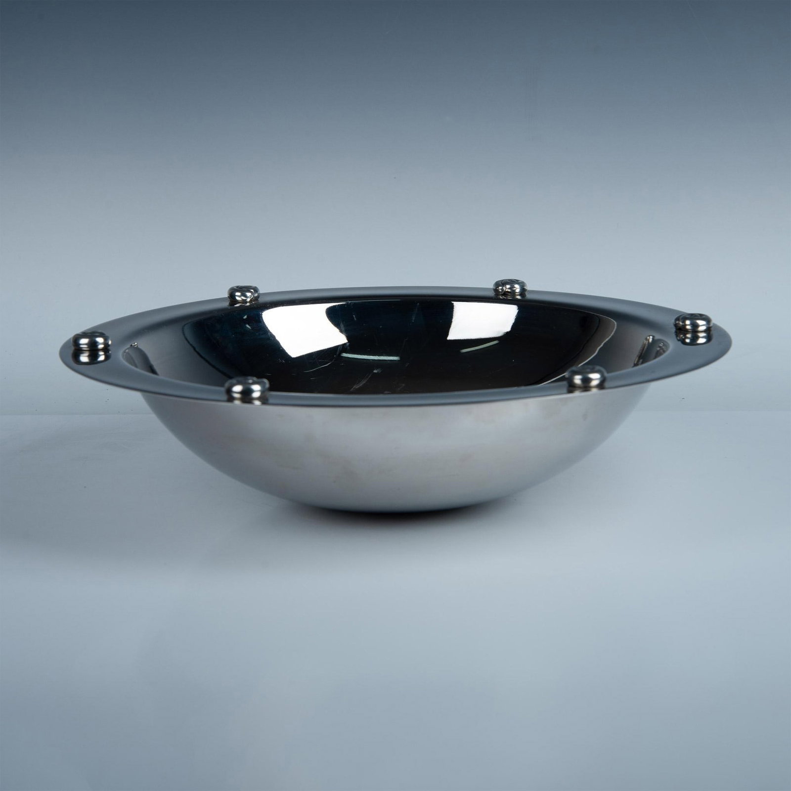 Carrol Boyes Stainless Steel Decorative Bowl, Wave: A generously-sized bowl with wave-like features fashioned from pewter on its rim. Carrol Boyes backstamp. Artist: Carrol Boyes Dimensions: 4''H x 16''dia Manufacturer: Carrol Boyes Country of Origin: 