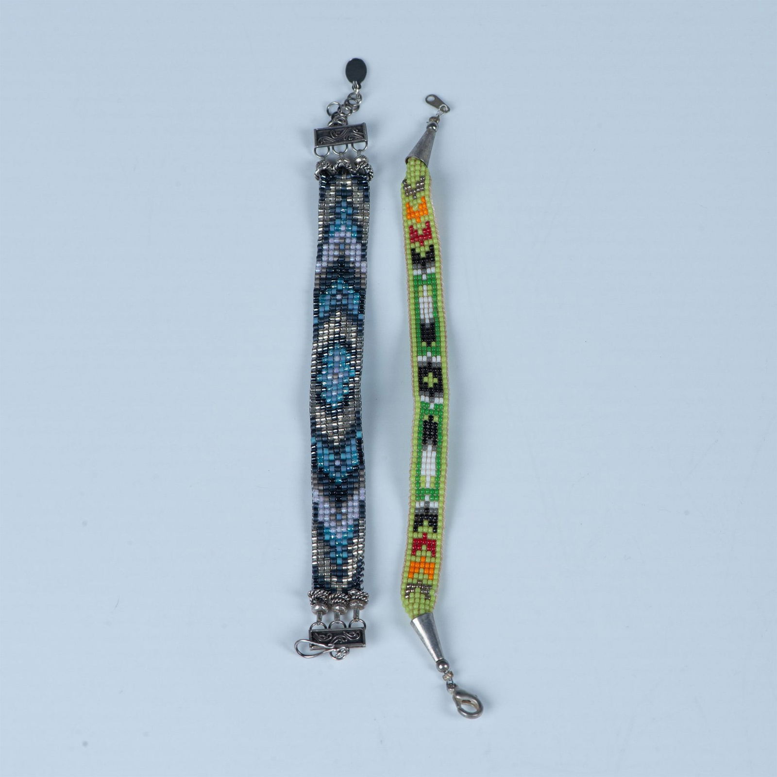 2pc Native American Hand-Woven Bead Bracelets: The blue and silver bracelet was made by Chipita and measures 8"L, but can be adjusted shorter. The green bracelet measures 7.5"L Country of Origin: United States