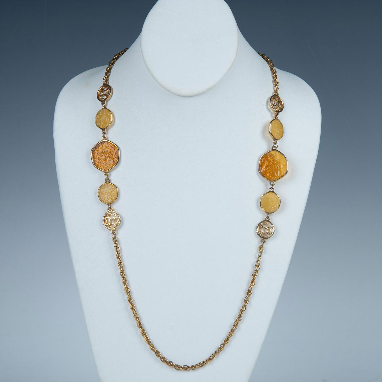 Sarah Coventry Taste of Honey Necklace: This necklace has a gold tone chain divided by two sections of decorative cream and honey colored lucite. Sarah Coventry tag near the spring ring clasp. Dimensions: 38.5"L Country of Origin: United St