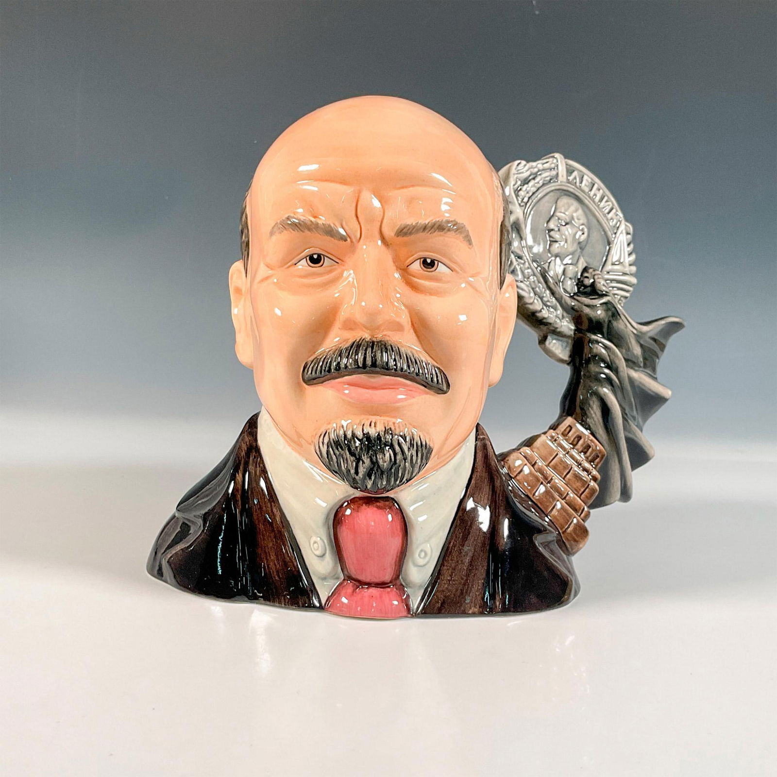 Vladimir Lenin D7289 - Large - Royal Doulton Character Jug: Limited edition, part of the Revolutionaries Collection. Royal Doulton backstamp. Certificate of Authenticity included. Artist: Caroline Dadd and Robert Tabbenor Issued: 2009 Dimensions: 8.5"L x 5.5"W