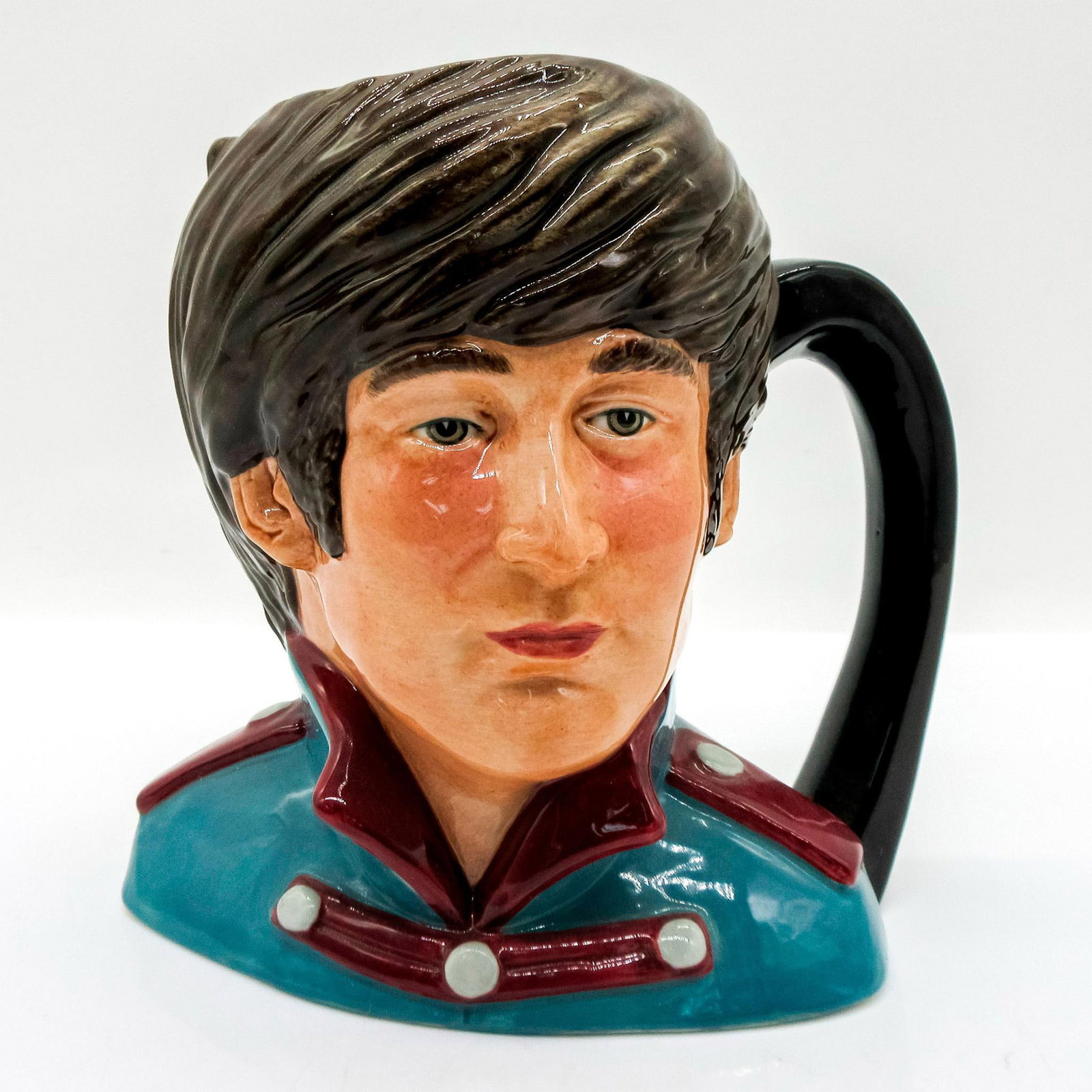 John Lennon D6725 - Odd Size - Royal Doulton Character Jug: Variation One, turquoise jacket with maroon collar and epaulettes. Series: The Beatles. Royal Doulton backstamp. Artist: Stanley J. Taylor Issued: 1984 - 1991 Dimensions: 5.5"H Manufacturer: Royal Dou